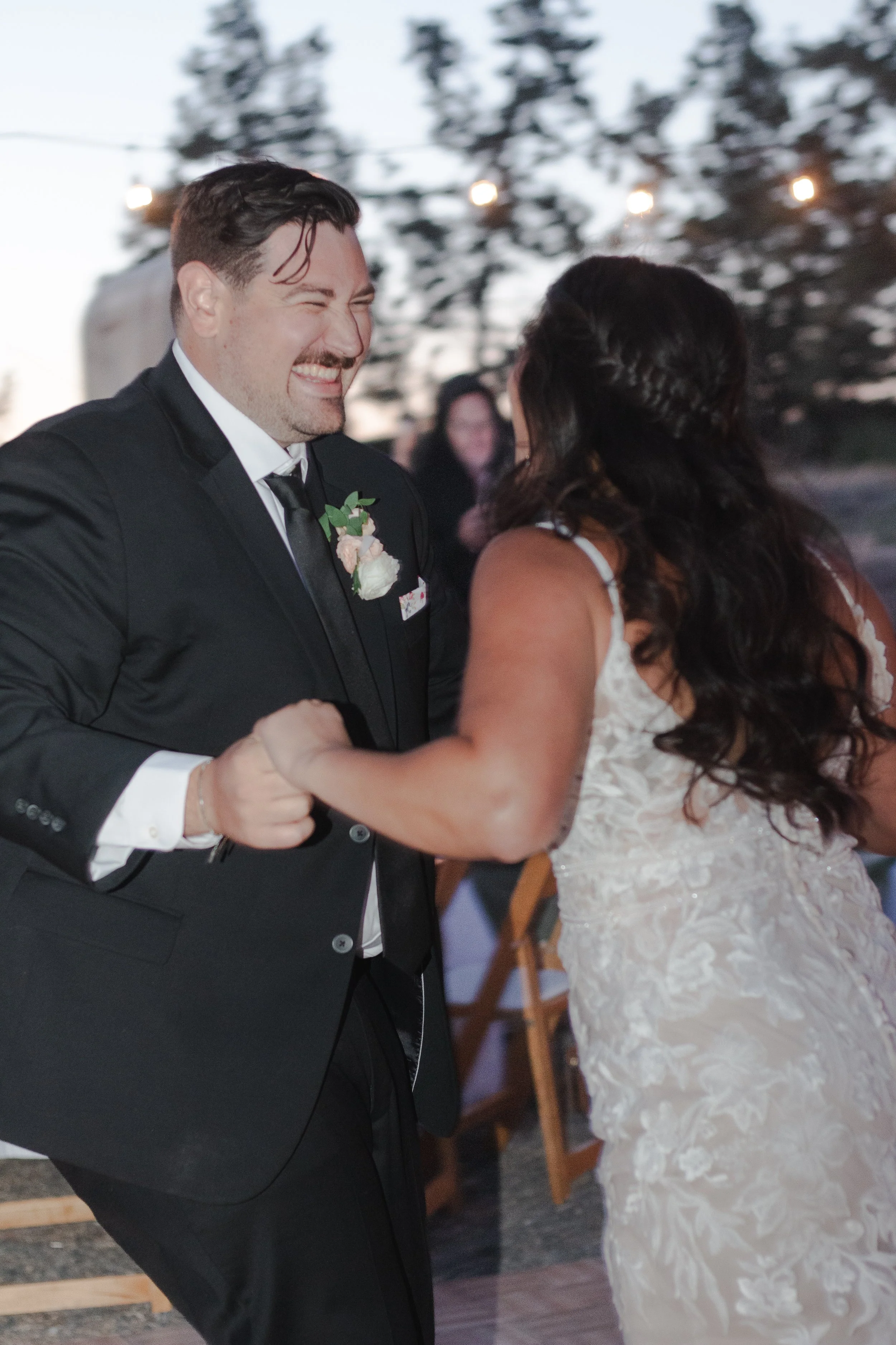  Bride and groom dancing beneath string lights at their private ranch wedding reception near Bend, Oregon 