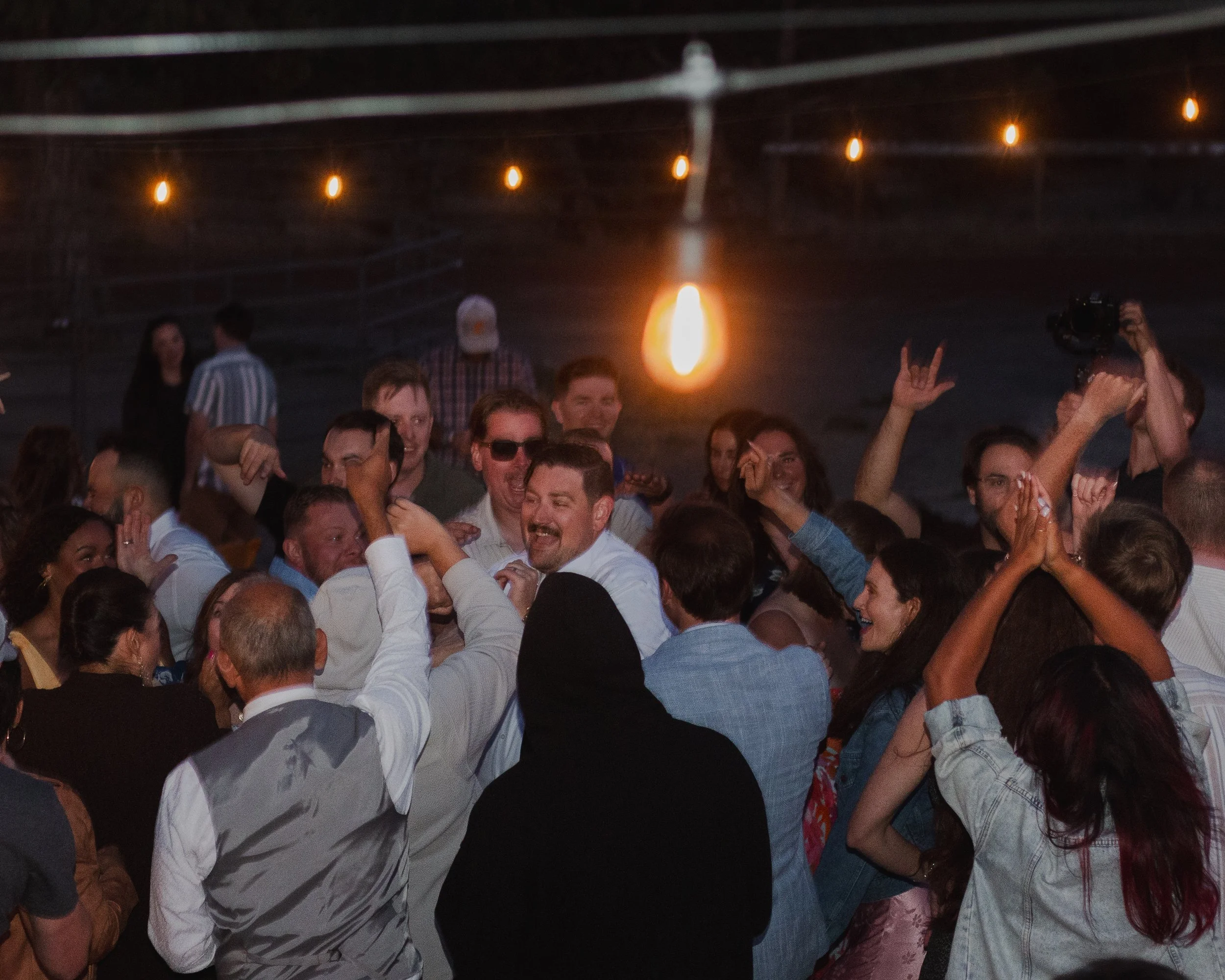  Packed wedding dance floor inside a string-lit ranch barn in Central Oregon 