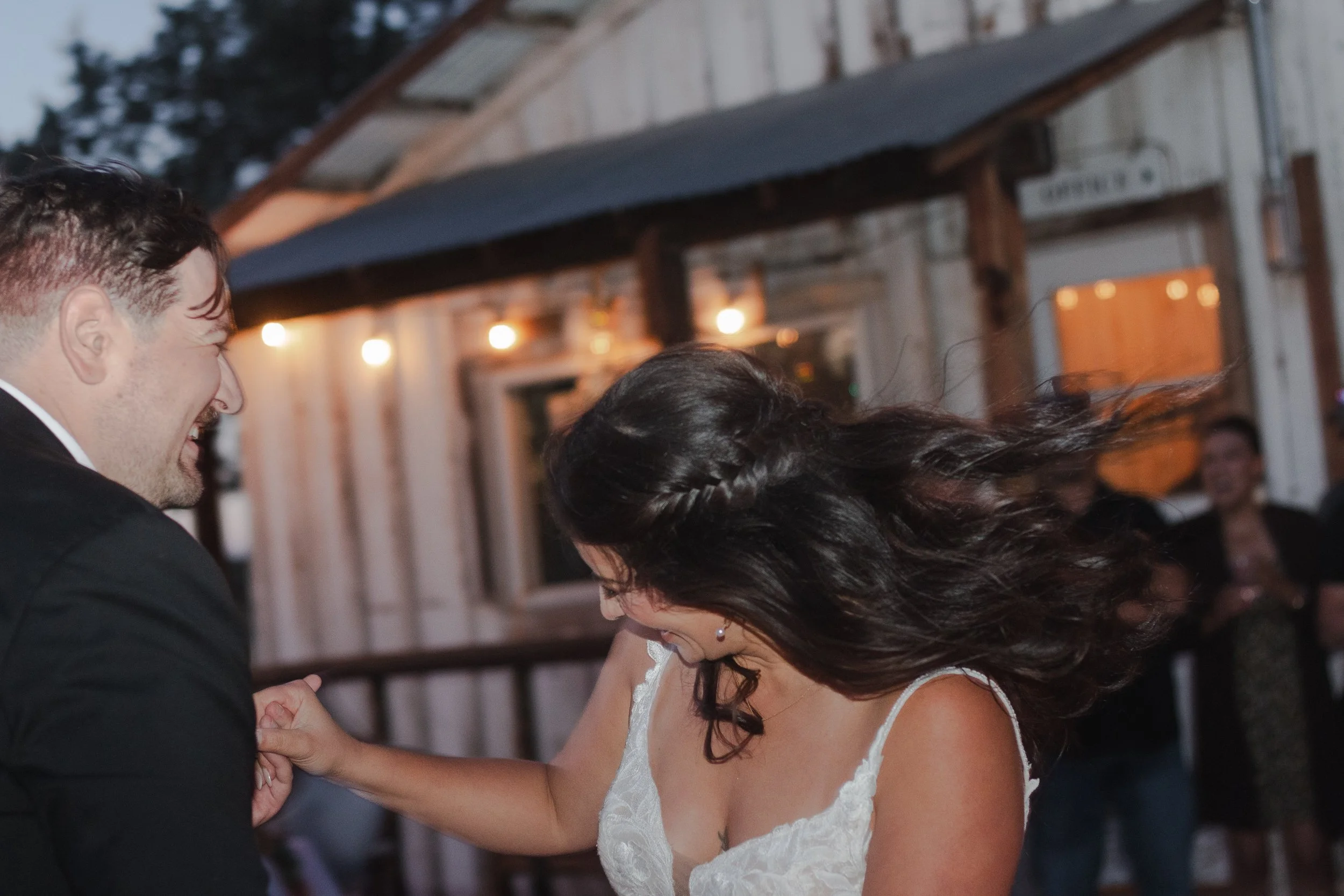  Bride and groom dancing beneath string lights at their private ranch wedding reception near Bend, Oregon 
