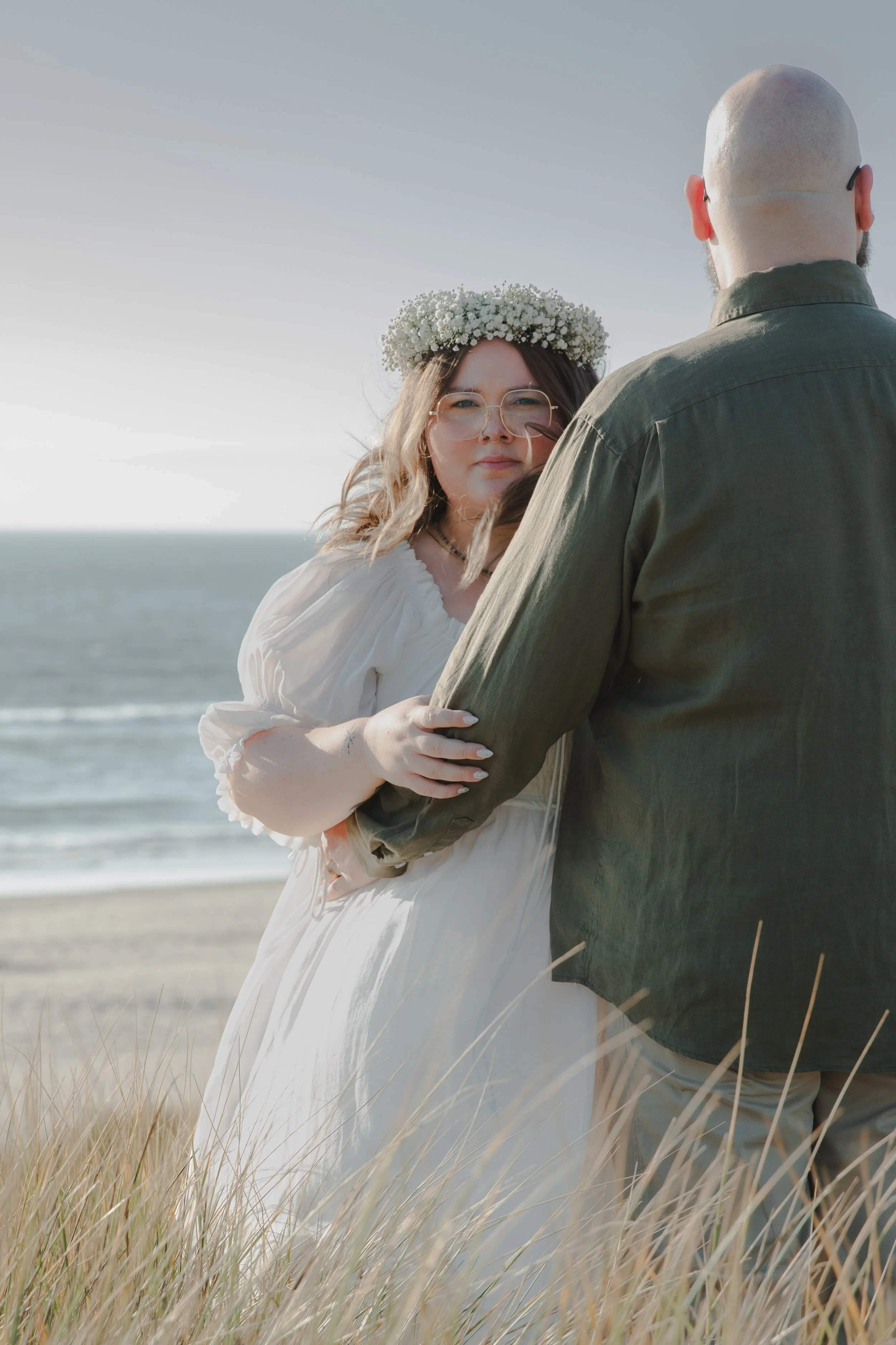 Cinematic engagement portrait on grassy bluffs near Manzanita Oregon