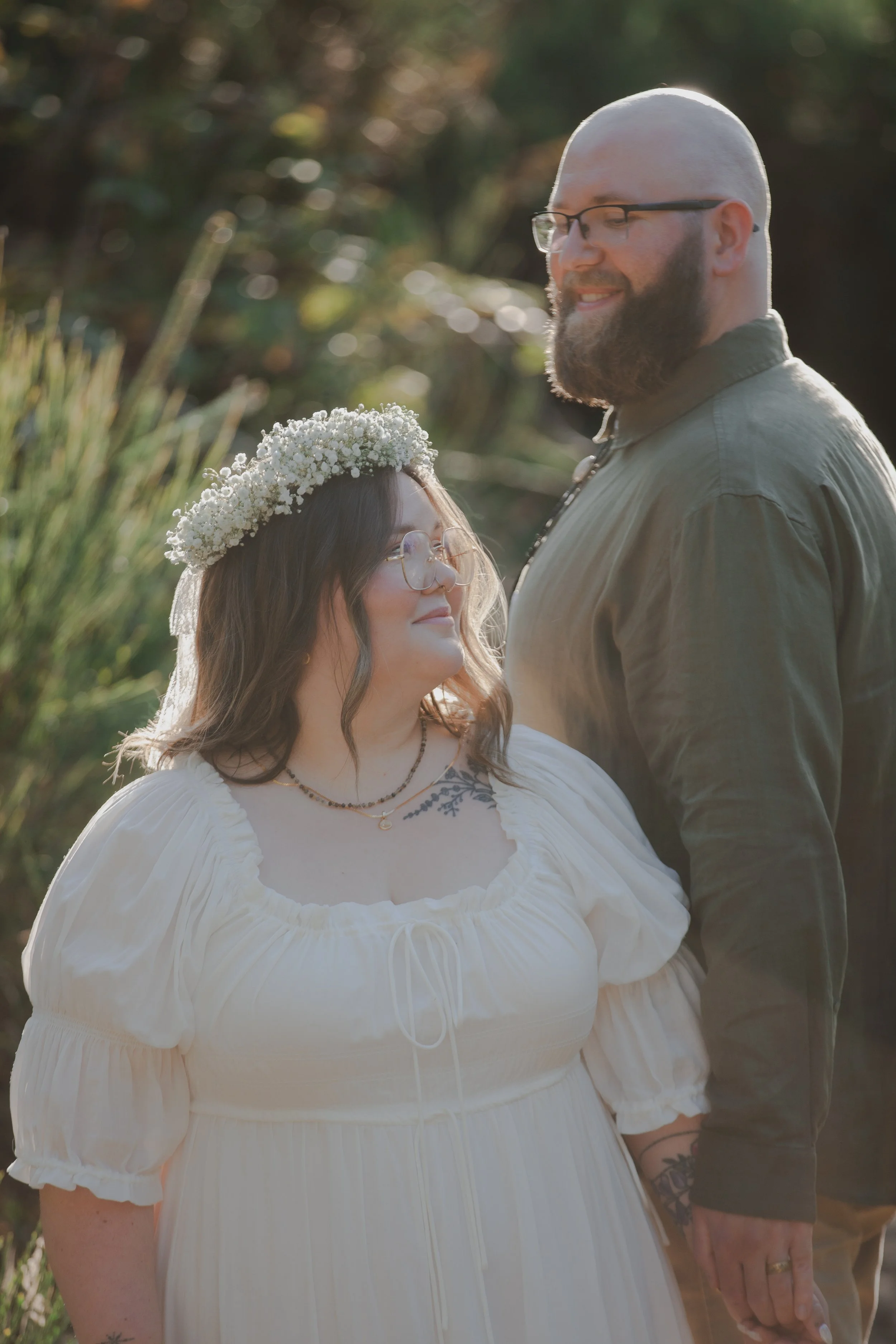 Couple walking through dune grass during Manzanita Oregon engagement session