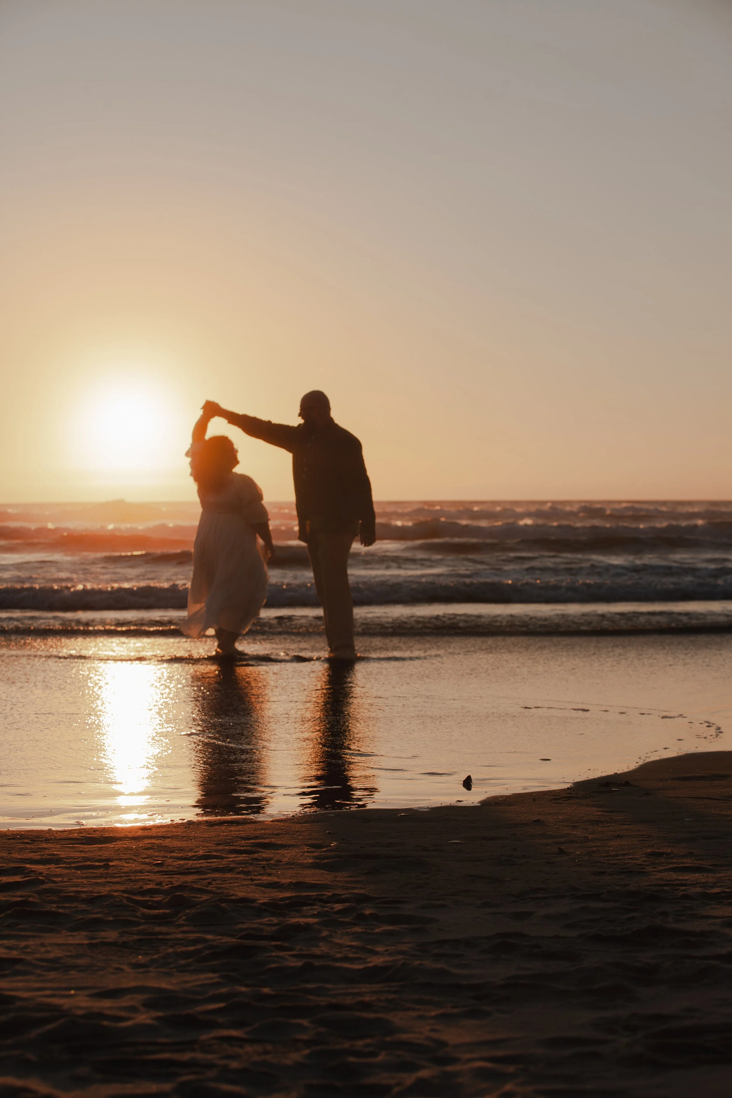 Silhouetted couple during September sunset on the Oregon Coast