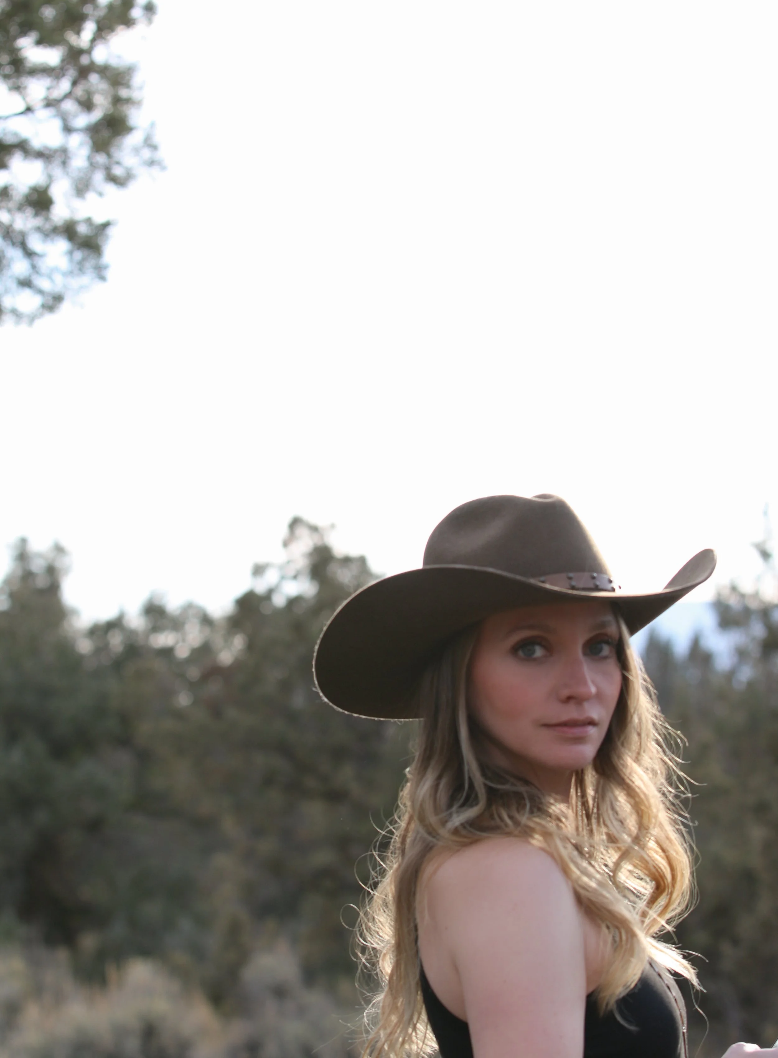 Portrait of Dominique Noel, editorial photographer documenting weddings, brands, portraits, and meaningful stories throughout Oregon and the American West.