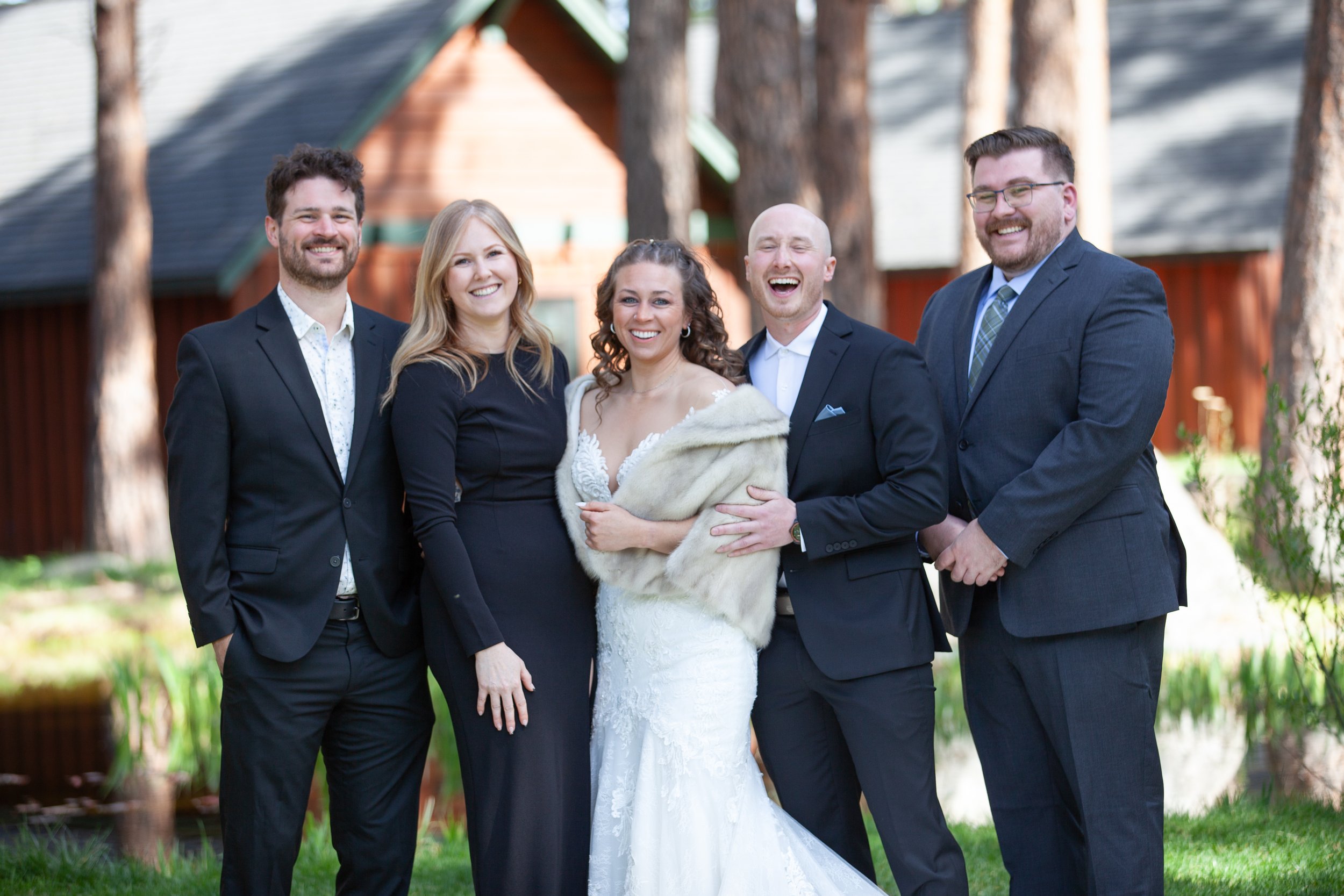 Wedding guests celebrating together beneath the pines. Five Pines Lodge. Sisters Oregon.