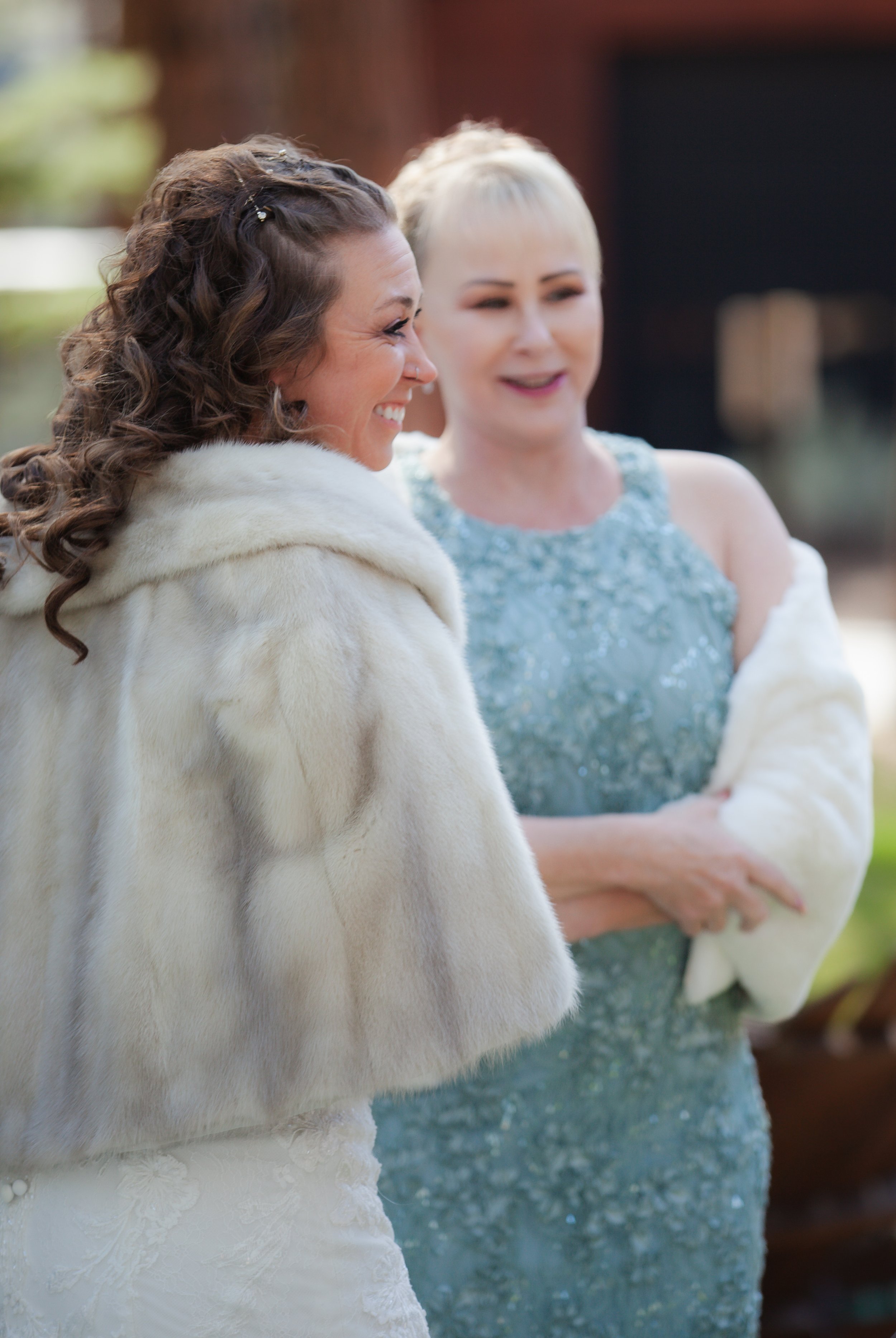 Emotional embrace between family members during the wedding celebration. Fine Pines Lodge. Sisters Oregon. 