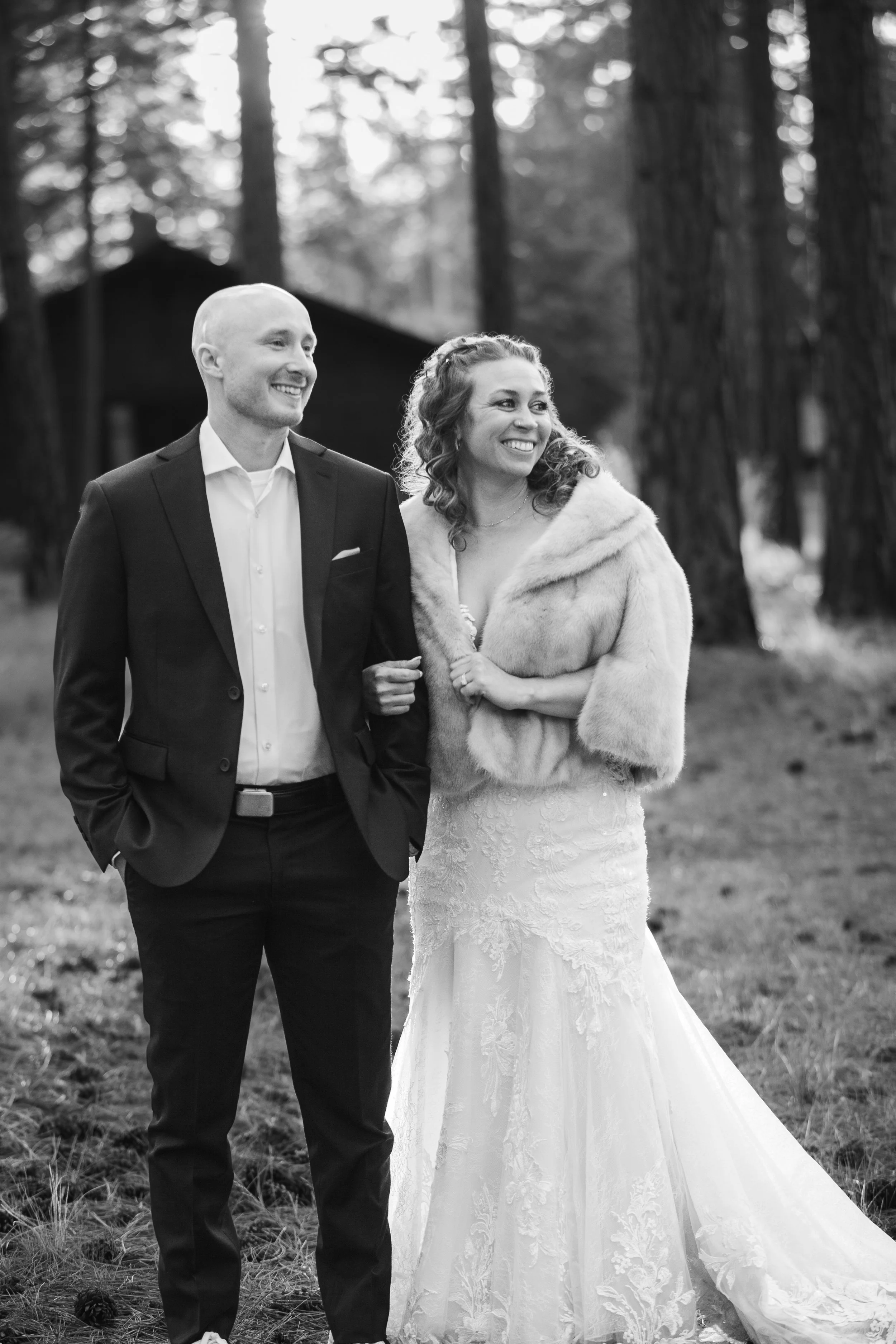 Black-and-white portrait of a bride and groom surrounded by pine forest at FivePine Lodge in Central Oregon.