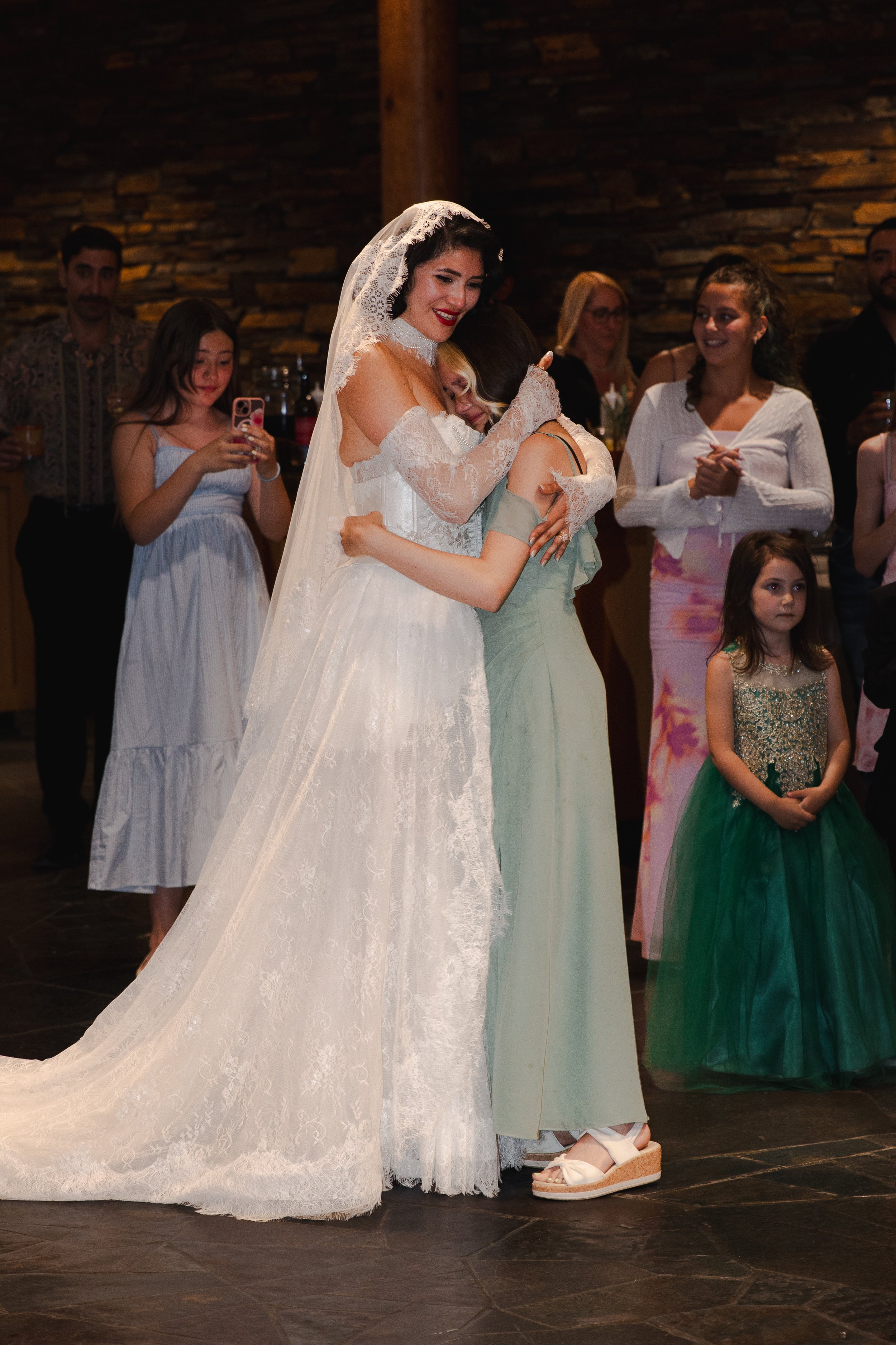 Bride celebrating with family and friends inside the High Desert Museum during her Bend, Oregon wedding
