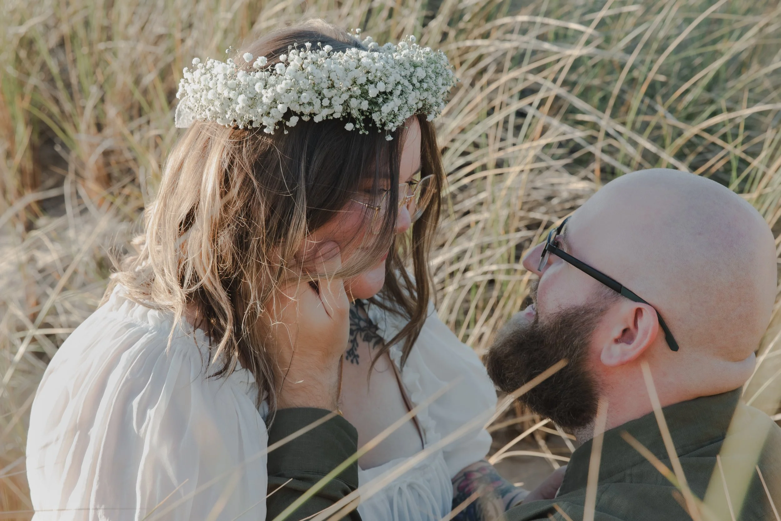 Cinematic engagement portrait on grassy bluffs near Manzanita Oregon