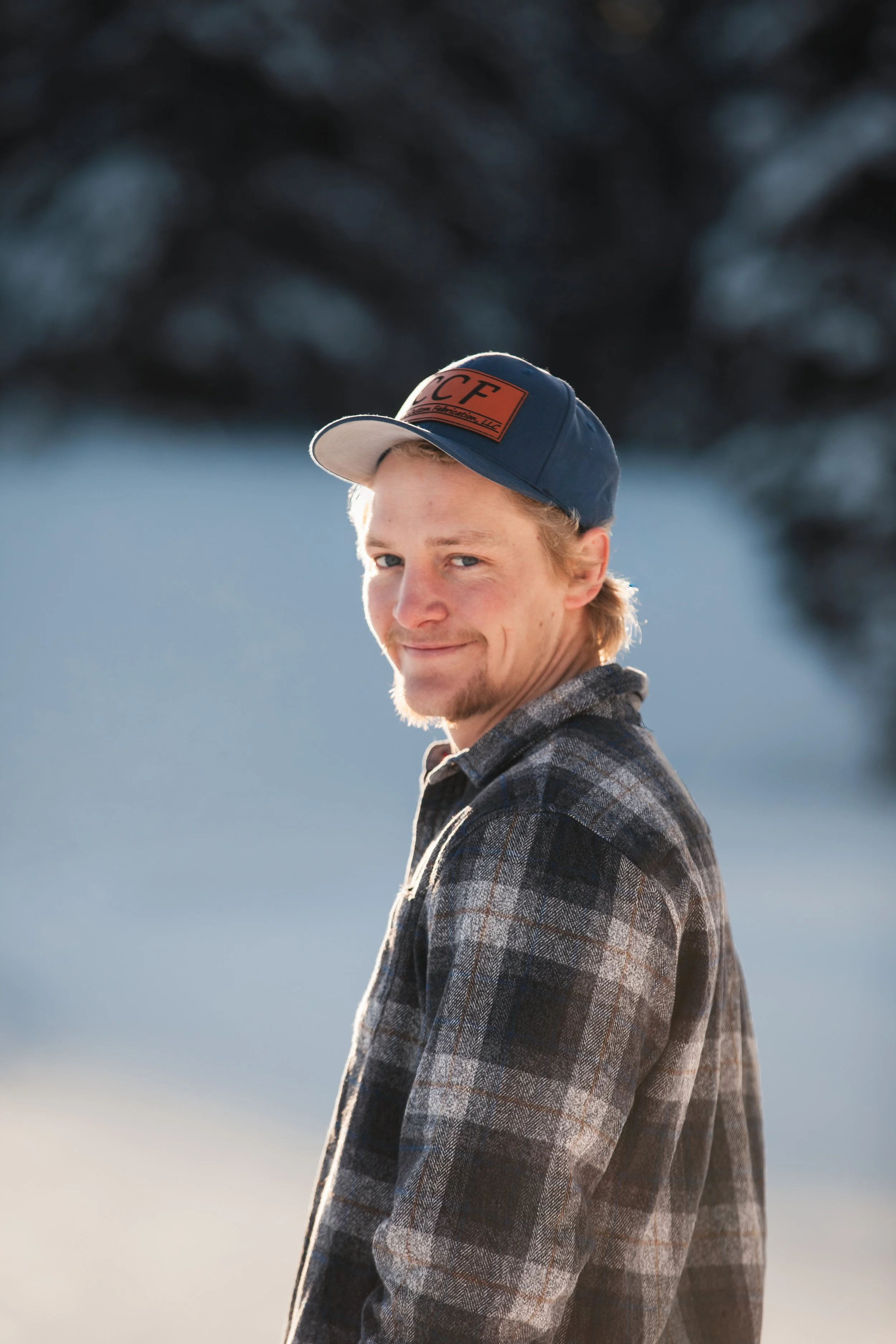 Groom-to-be portrait in a snowy Idaho forest during a winter engagement session near McCall.
