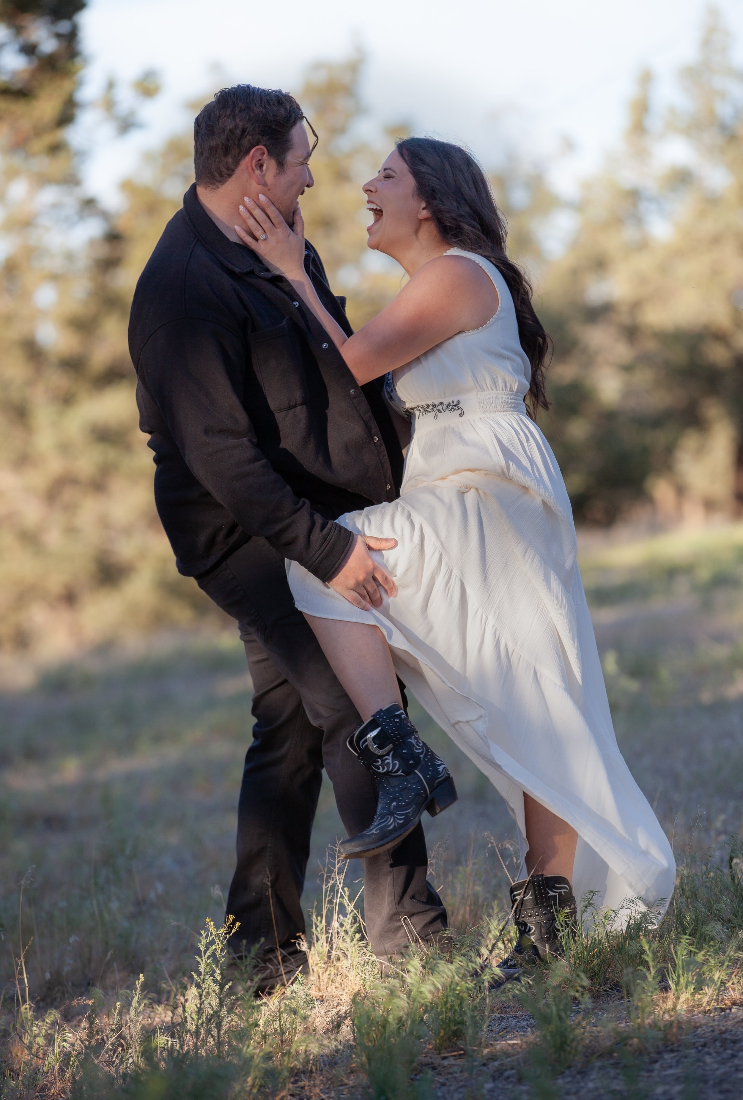 Couple exploring sagebrush trails beneath warm evening light. Central Oregon.