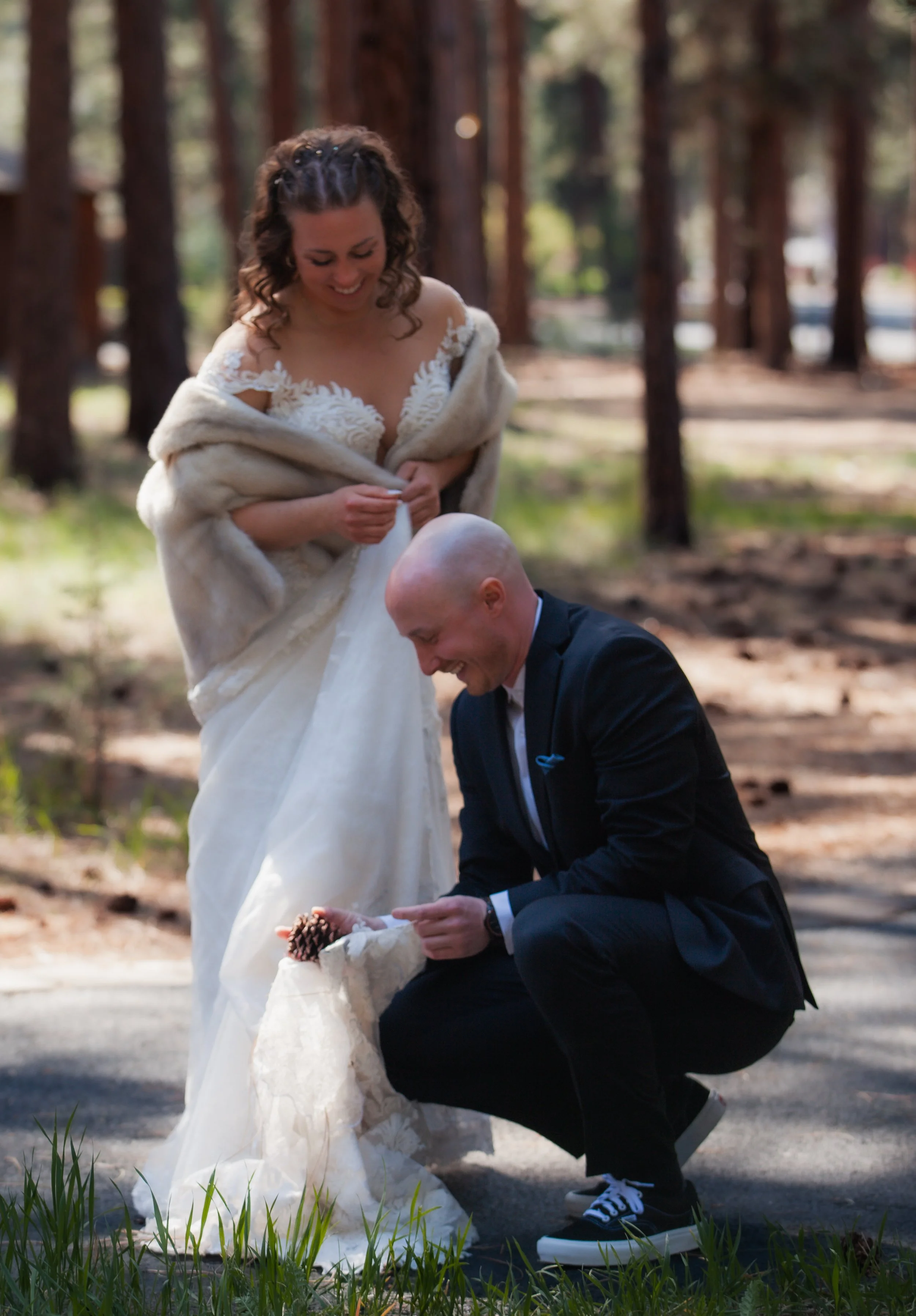 Bride and groom embracing beneath towering ponderosa pines. Five Pines Lodge. Sisters Oregon. 