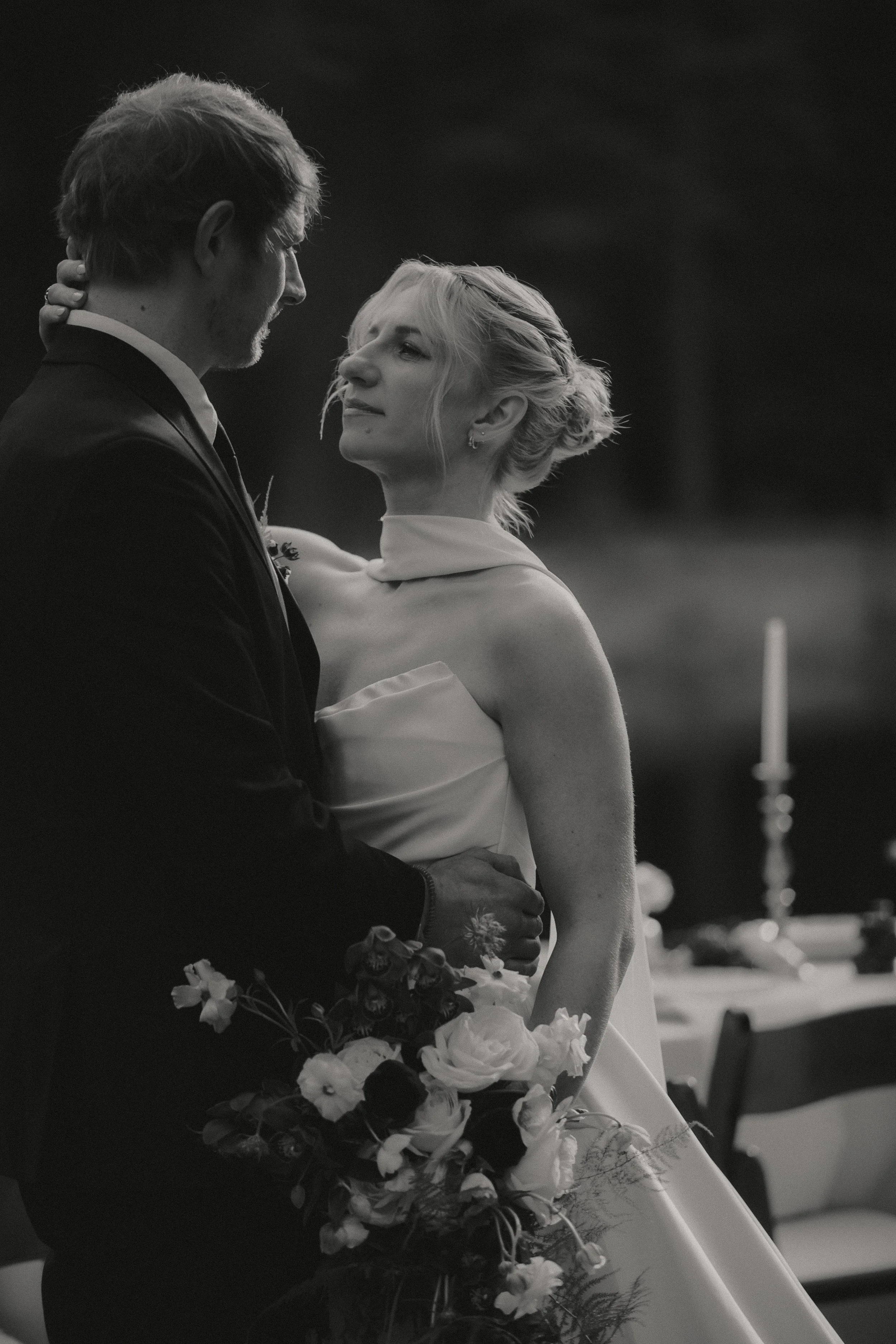 Black-and-white portrait of a bride and groom surrounded by the forest near Camp Sherman, Oregon.