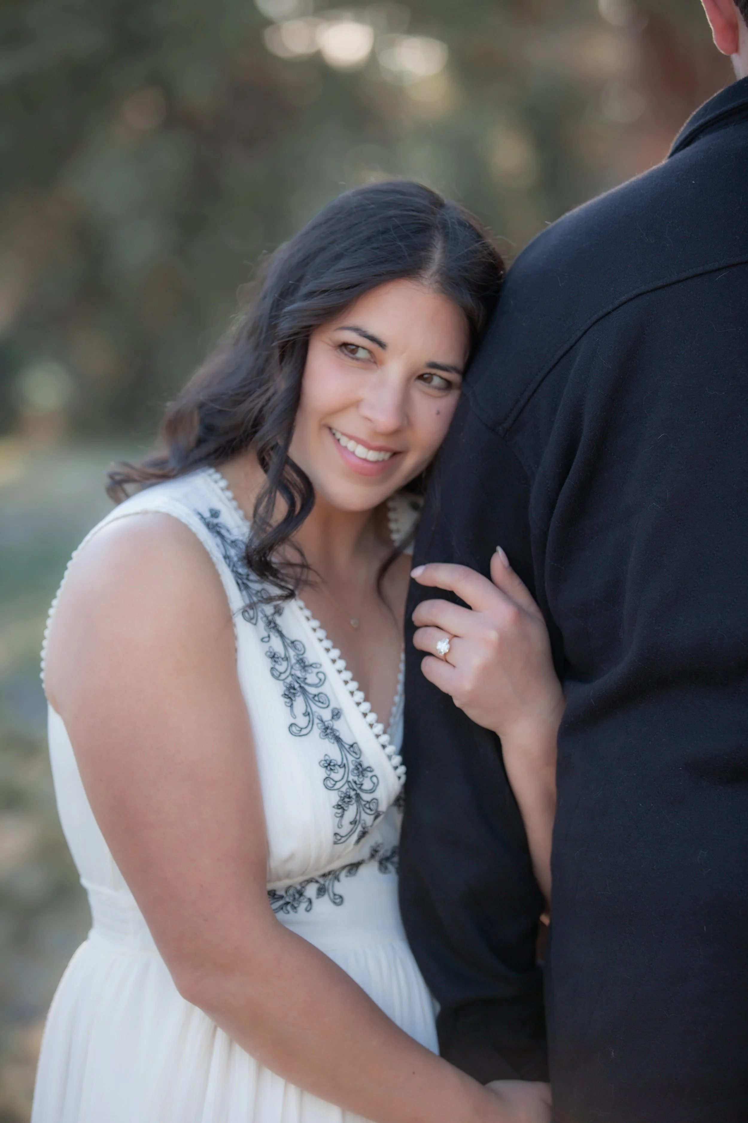 Close engagement portrait highlighting the bride-to-be's ring during a relaxed Central Oregon ranch session.