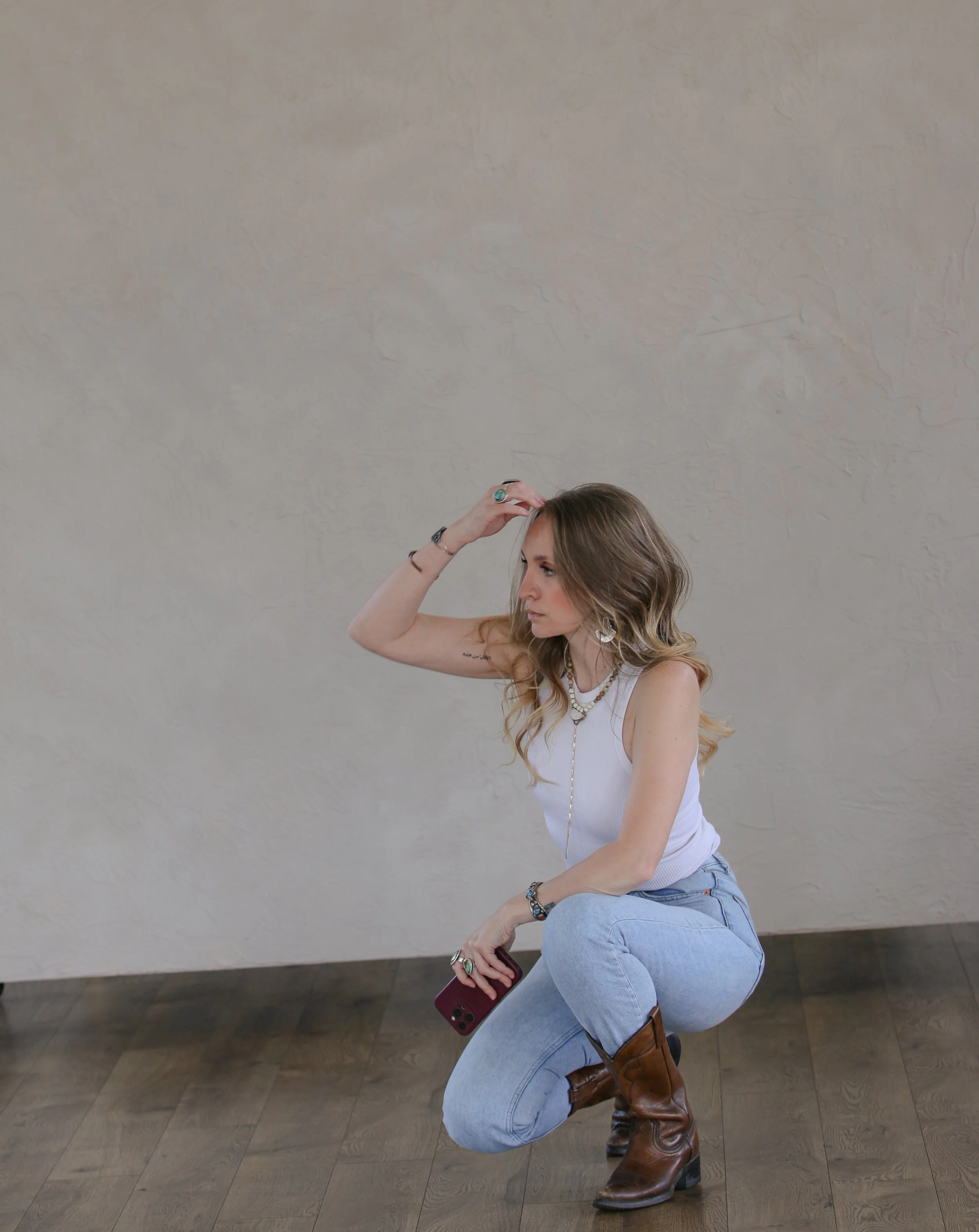 Dominique photographing a client during a portrait session, offering hands-on direction and thoughtful guidance.