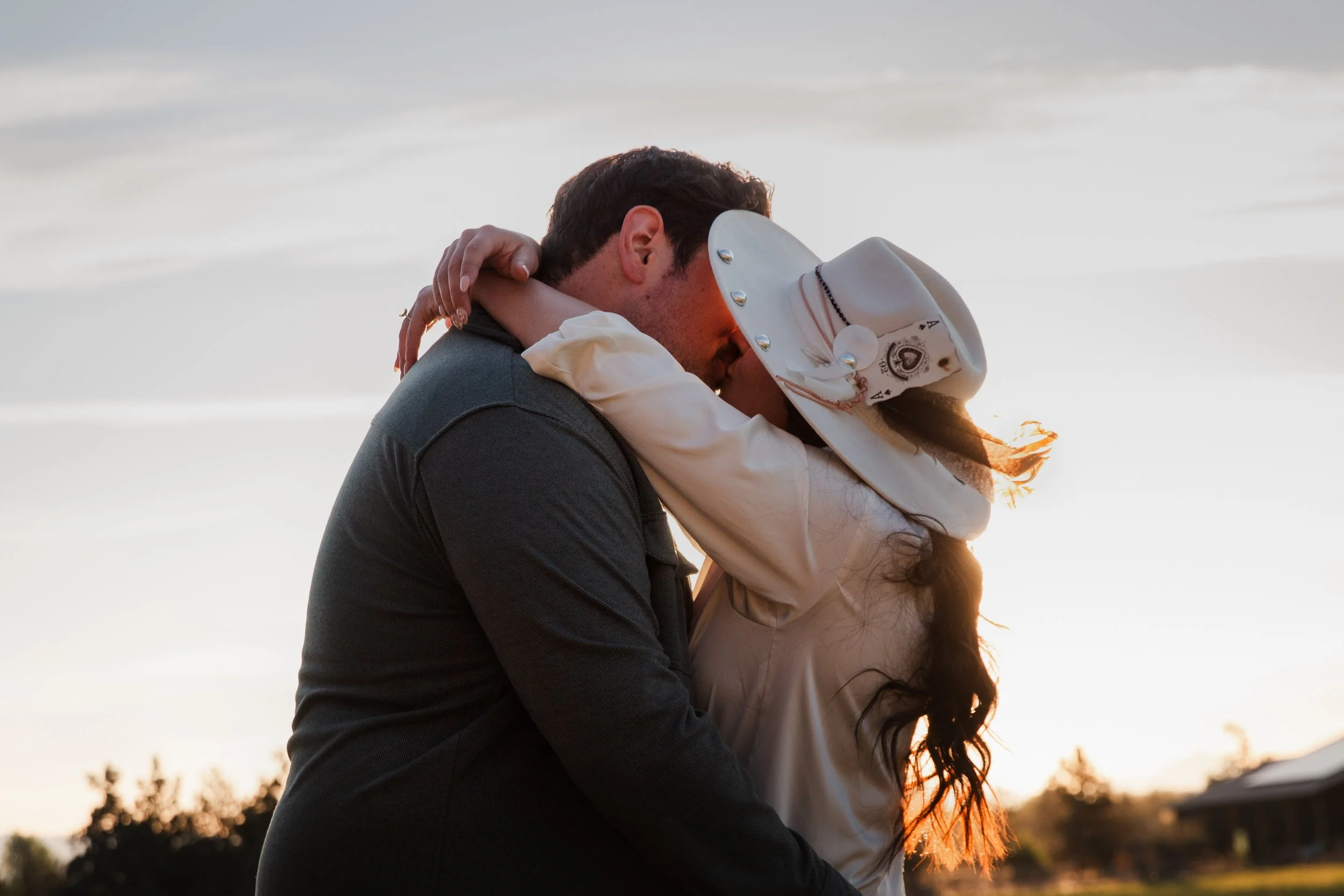 Couple exploring sagebrush trails beneath warm evening light. Bend Oregon.