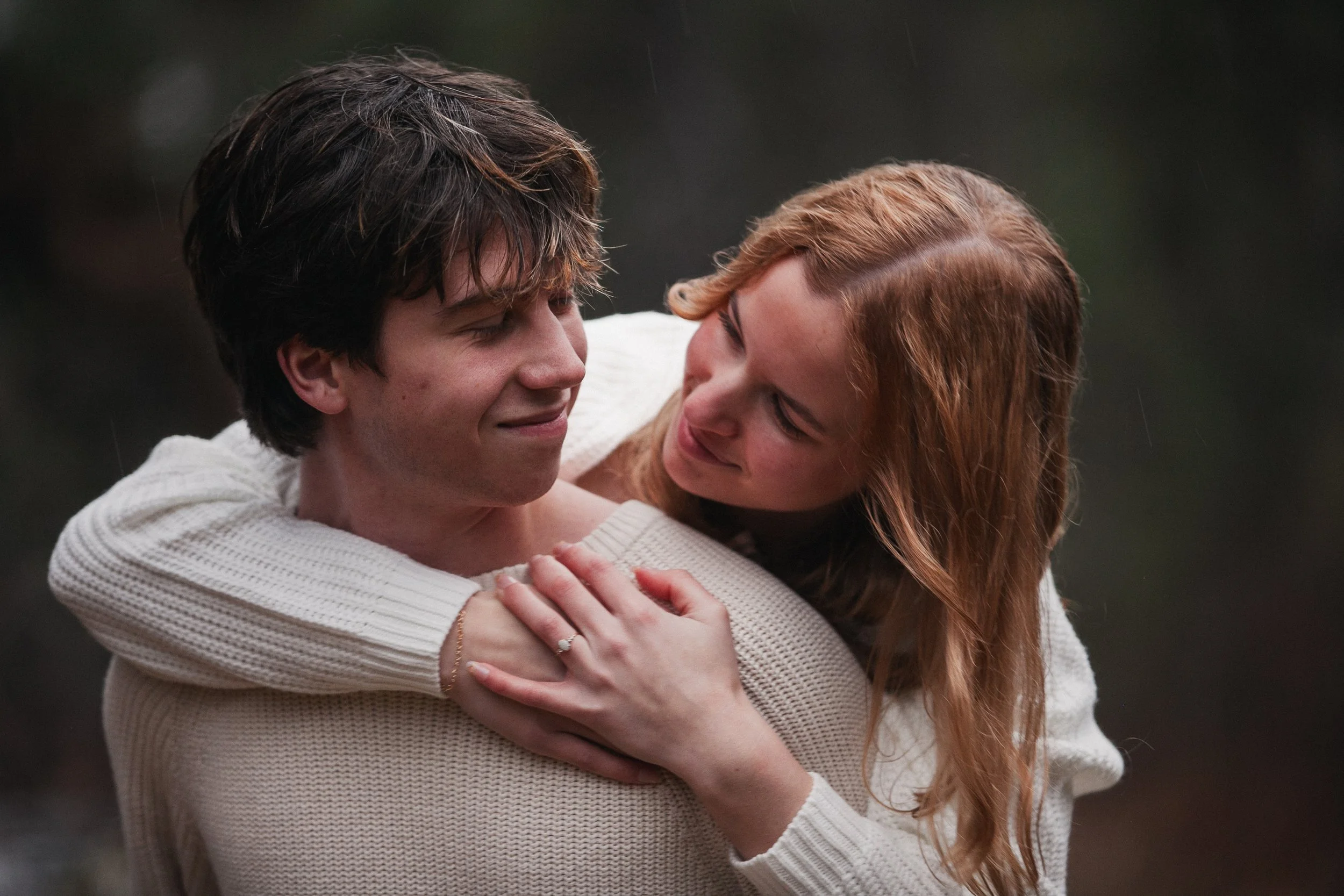 Romantic engagement portrait of a bride and groom embracing beside the Metolius-area forest near Camp Sherman.