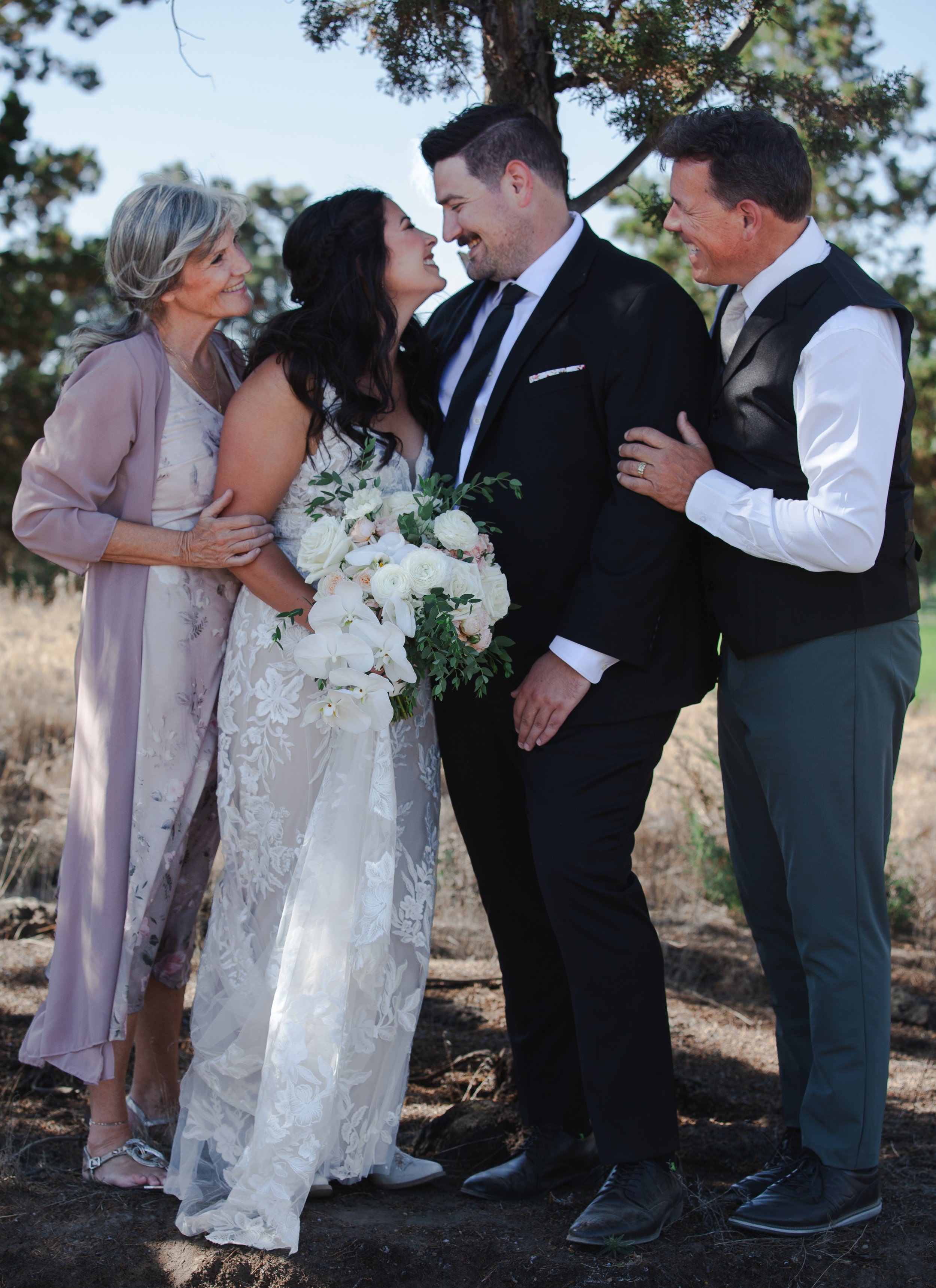 Bride and groom with family during their outdoor private ranch wedding in Central Oregon.