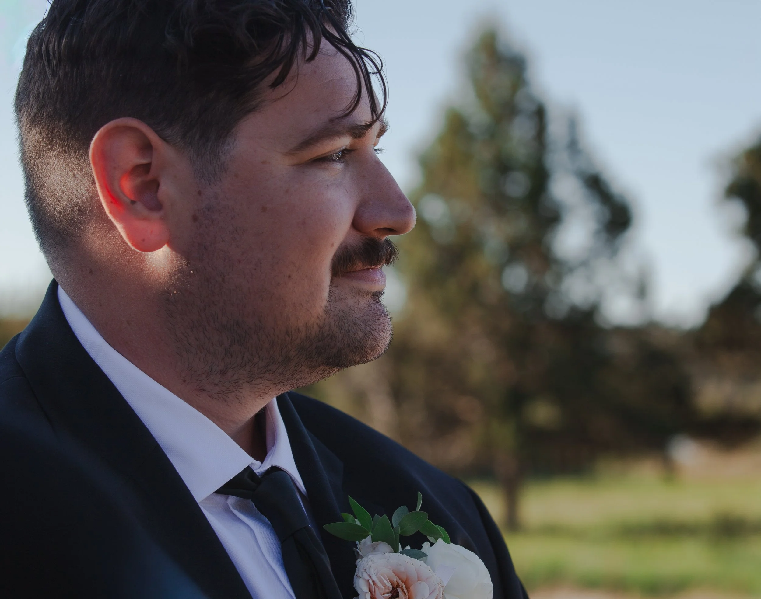 Emotional portrait of the groom watching his bride during their Central Oregon wedding ceremony.