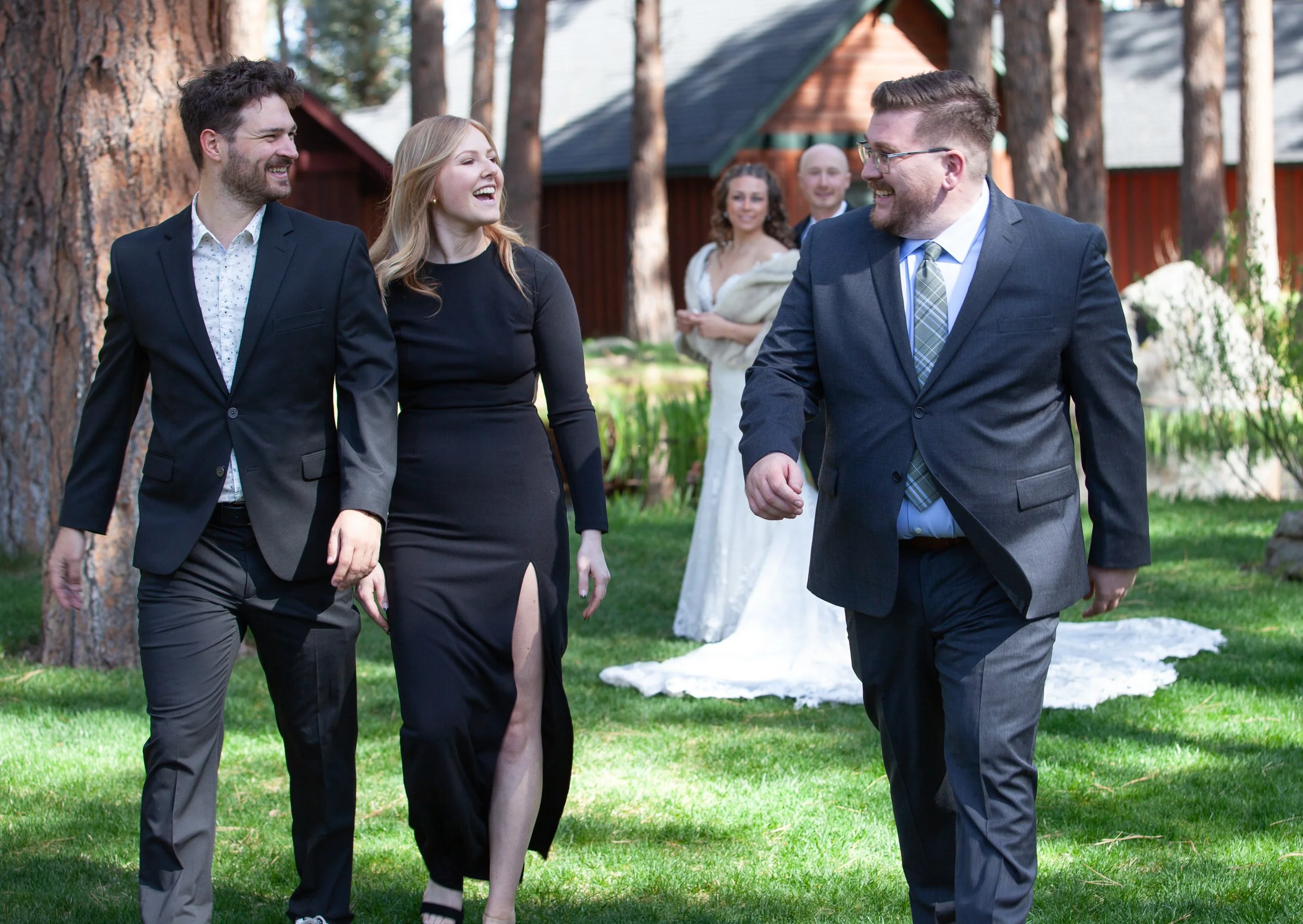 Wedding guests celebrating together beneath the pines. Five Pines Lodge. Sisters Oregon.