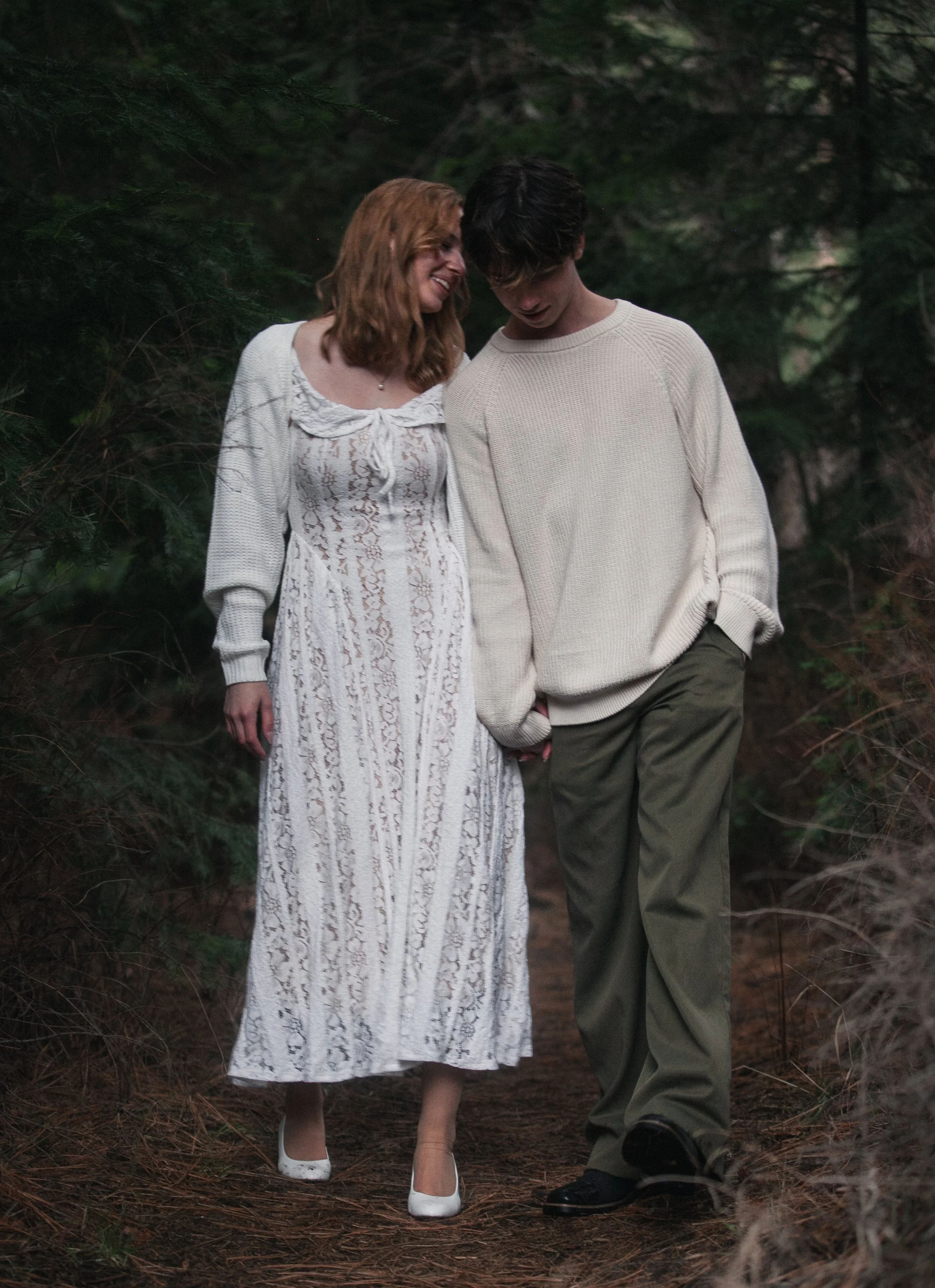 Romantic engagement portrait of a bride and groom embracing beside the Metolius-area forest near Camp Sherman.