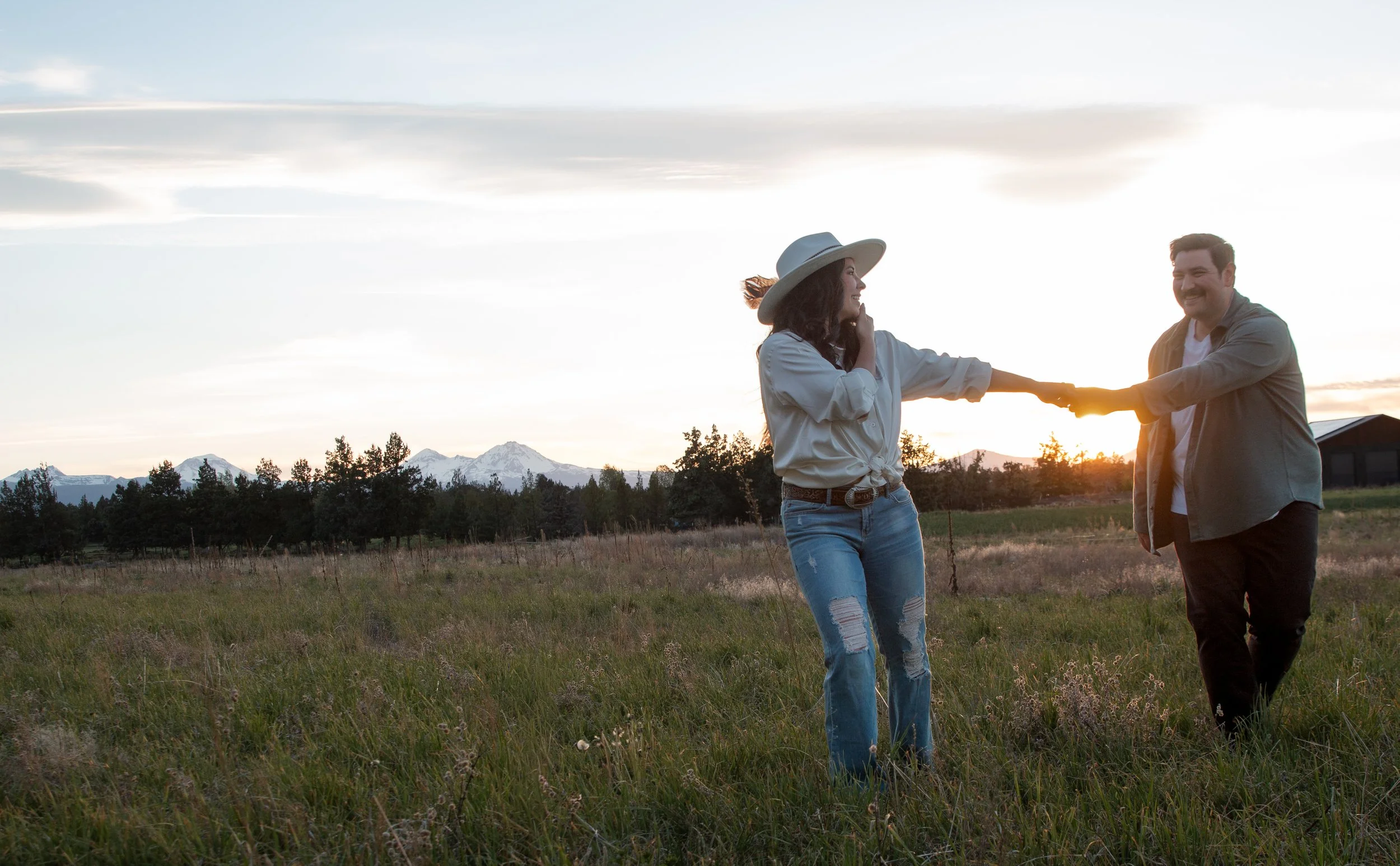 Couple laughing together during a relaxed engagement session. Bend Oregon.