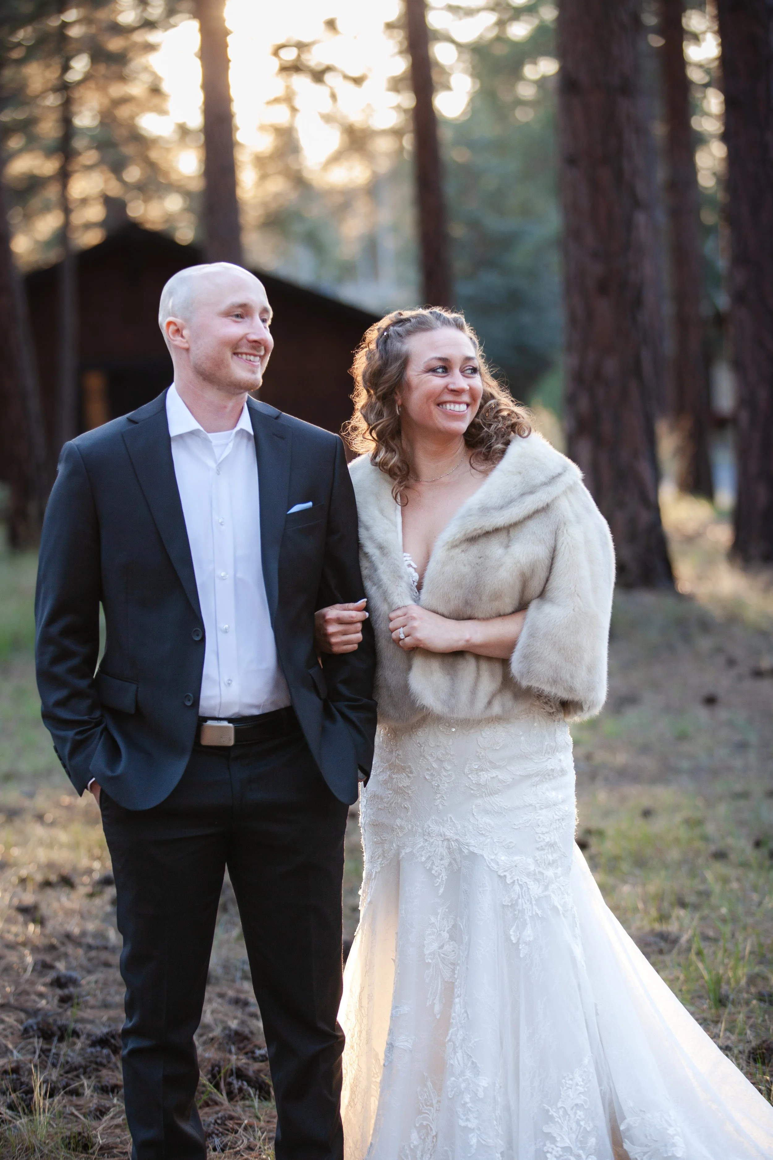 Bride and groom embracing beneath towering ponderosa pines. Five Pines Lodge. Sisters Oregon. 