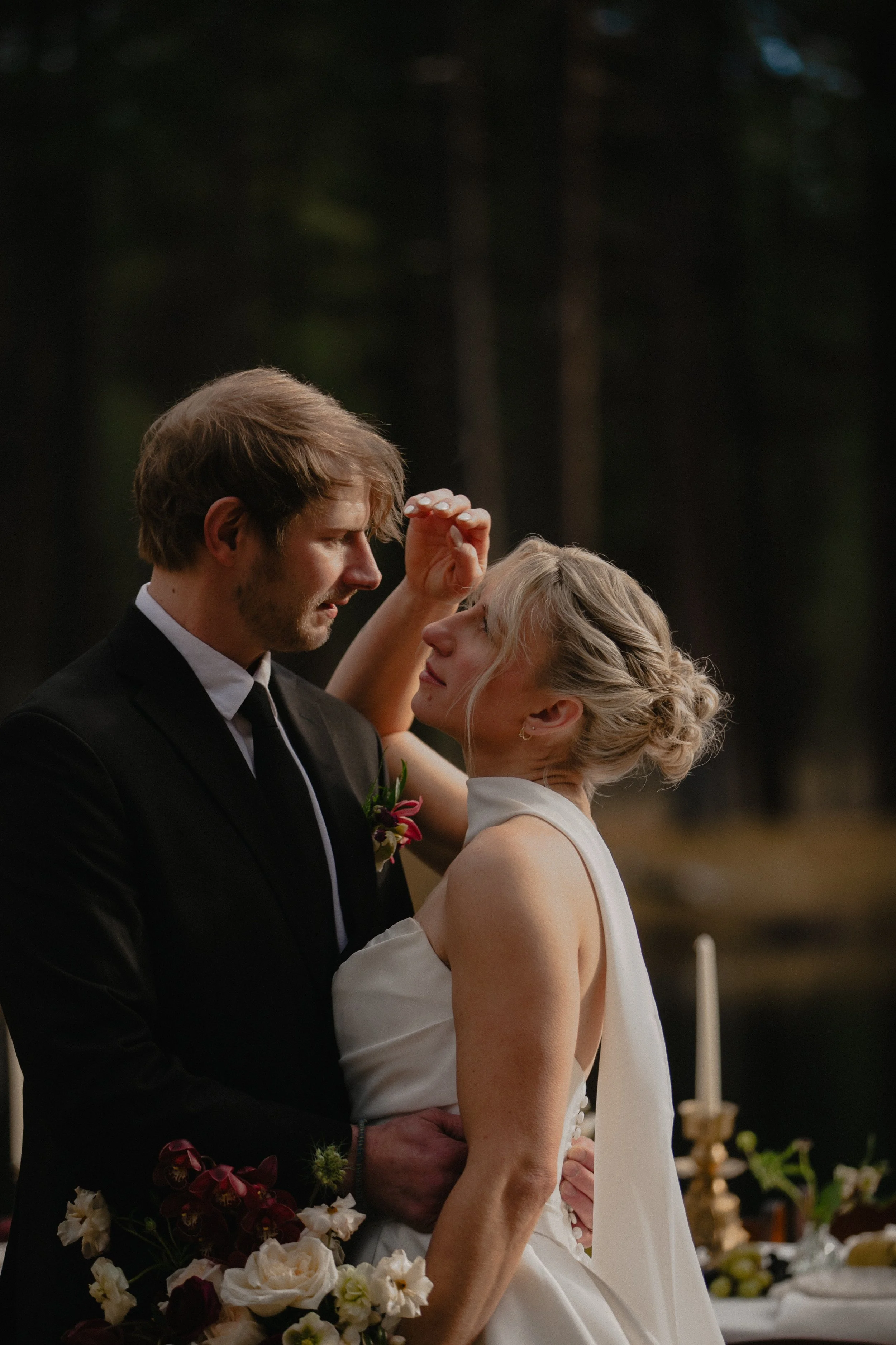 Bride and groom embracing in warm winter light during a Central Oregon wedding editorial.