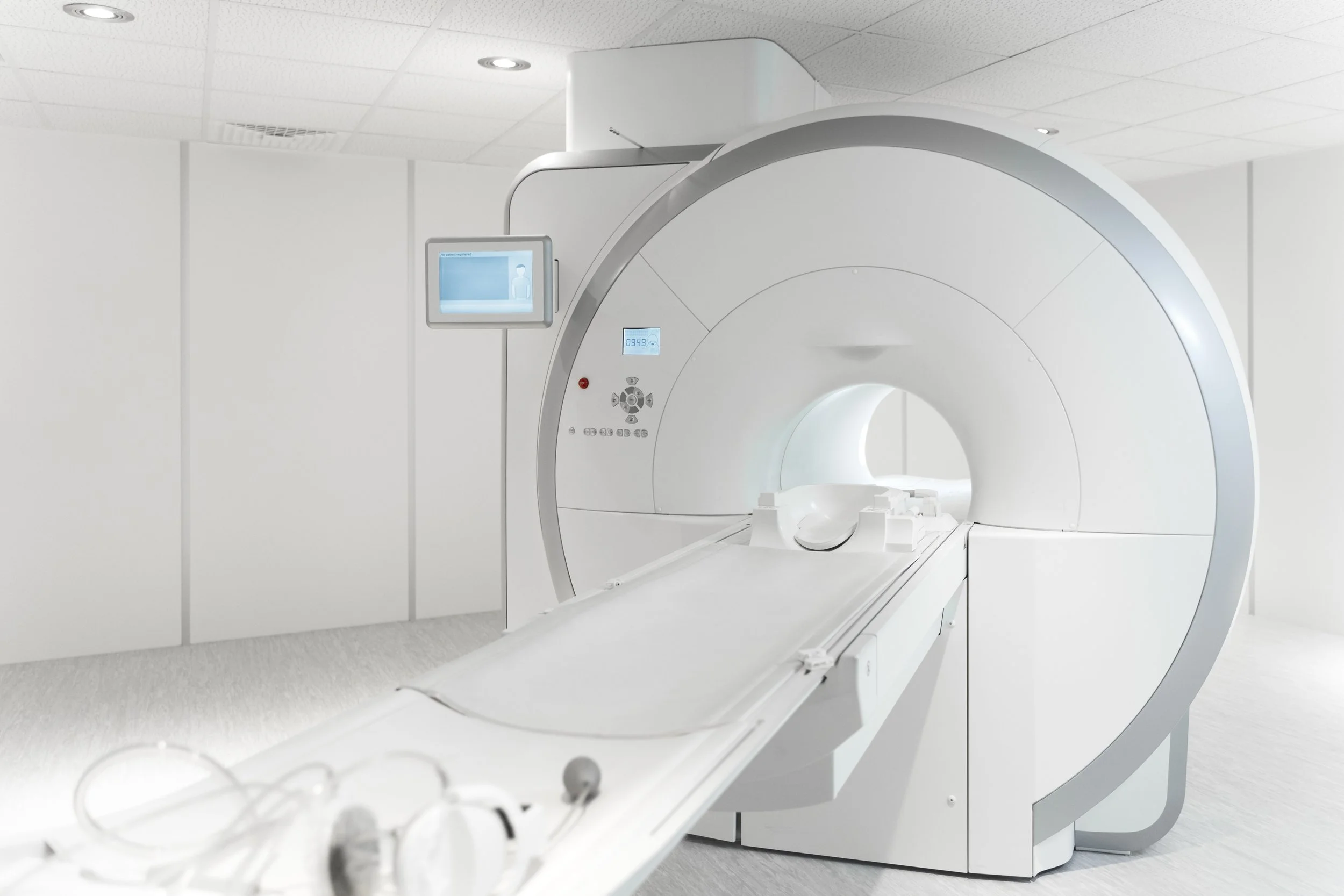 A modern MRI machine in a clean, bright medical room.