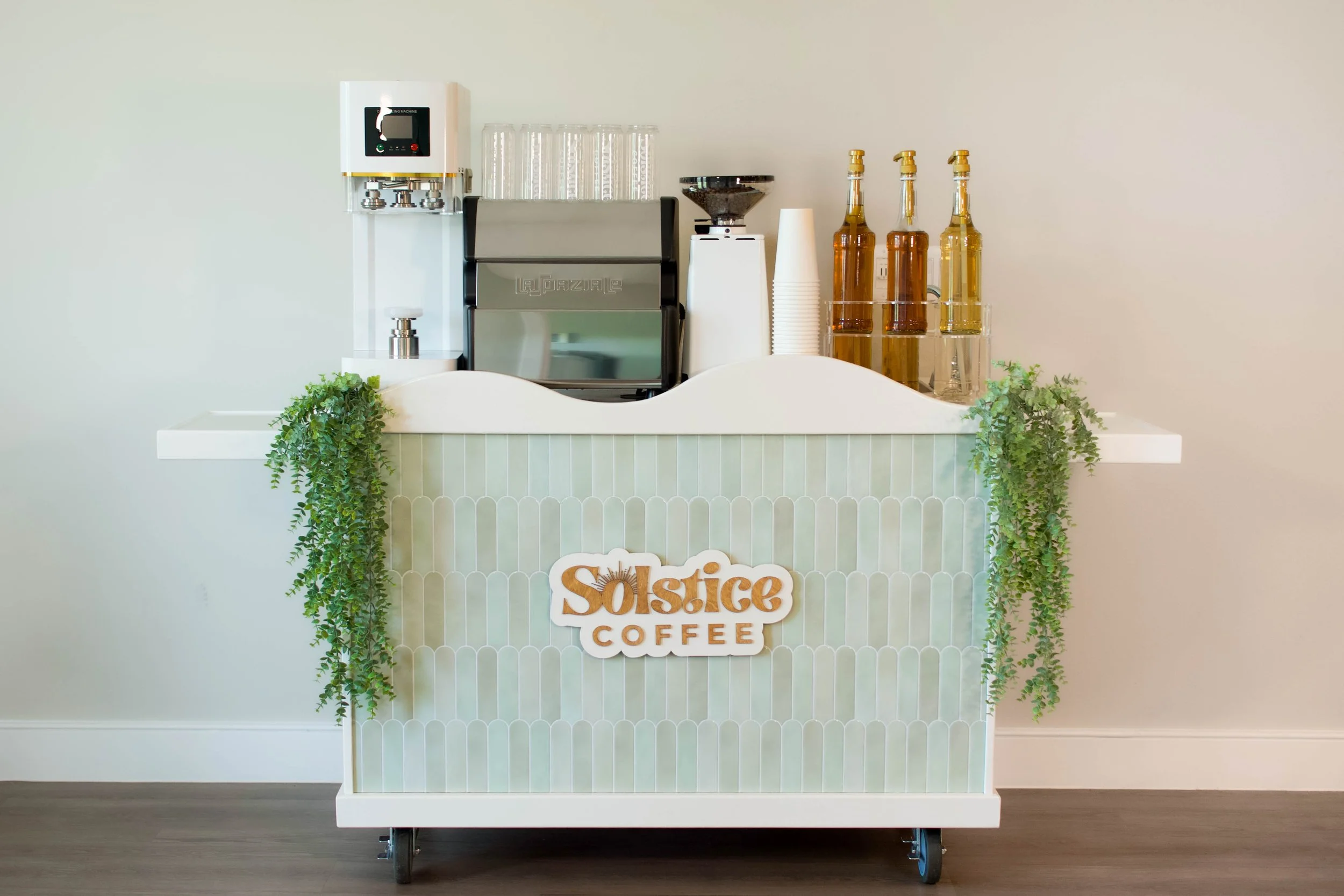 A green mobile coffee cart used for events in austin texas.