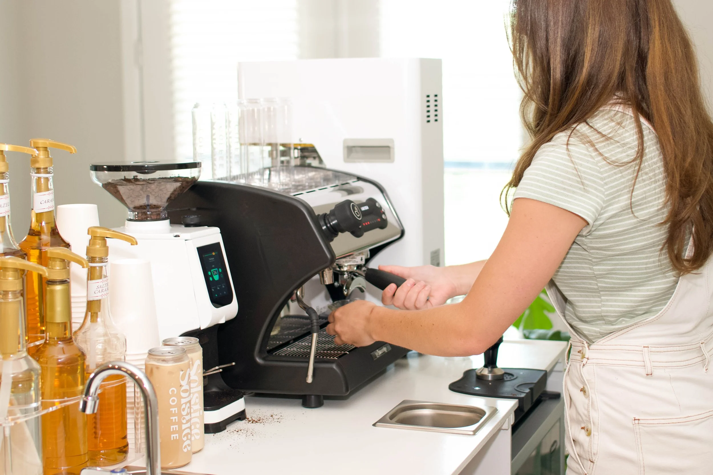 A barista serving coffee from her coffee cart at a corporate event in austin texas.