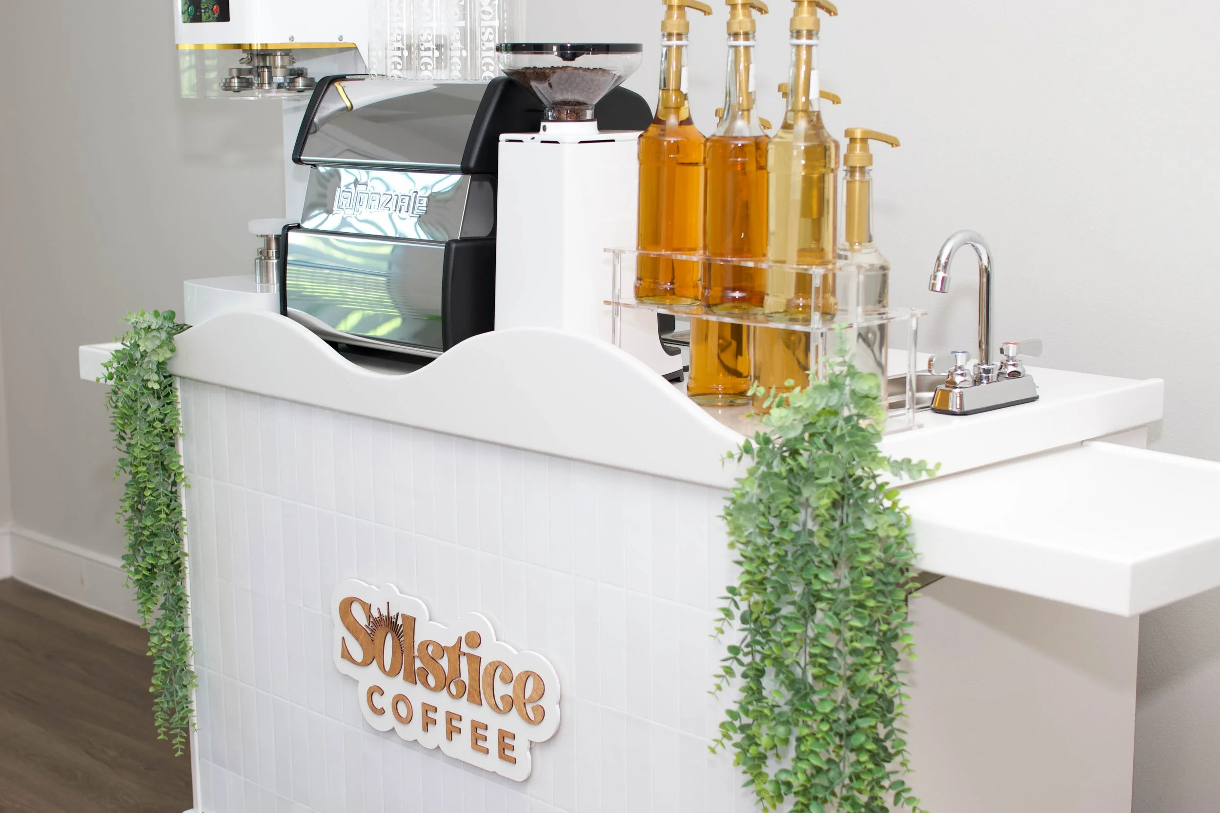 A white coffee cart that is used for weddings in austin texas.
