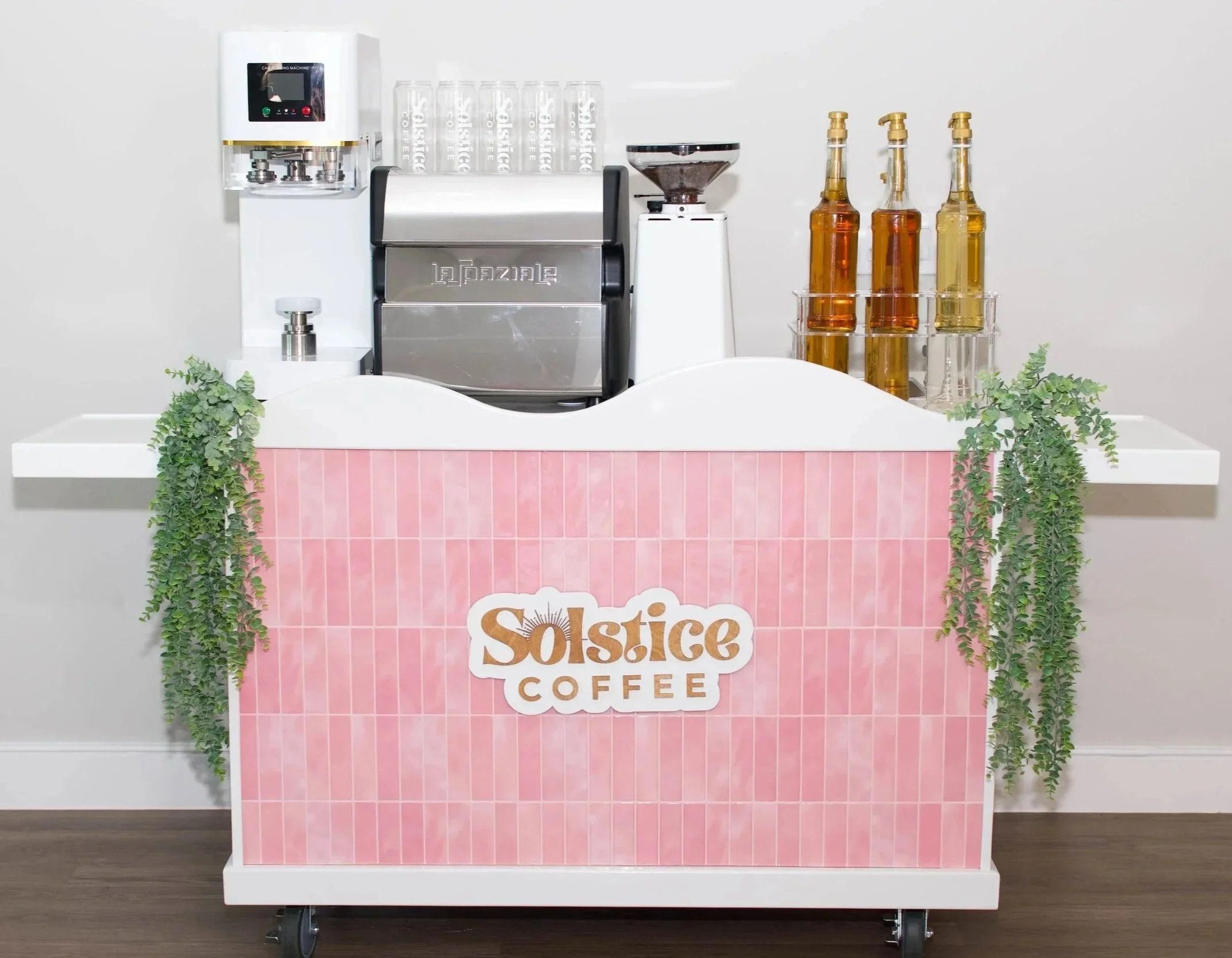 A pink mobile coffee cart used for serving coffee such as lattes, cappuccinos and americanos.