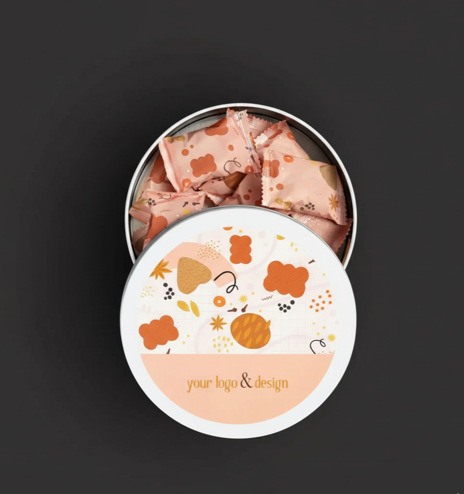 Open round tin container with pink candies inside, featuring a design with abstract shapes and the text 'your logo & design' on the lid.