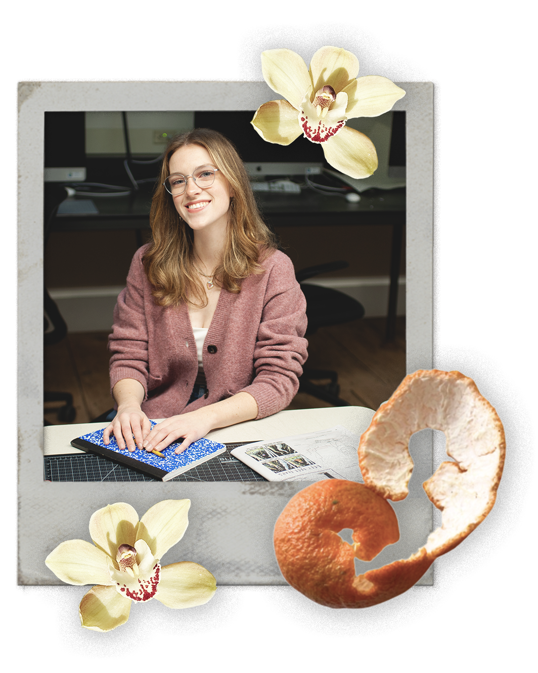 A woman with glasses, smiling, sitting at a desk with notebooks and papers, with a computer in the background. The image is framed with flowers, a peeled orange, and orange peels around it.