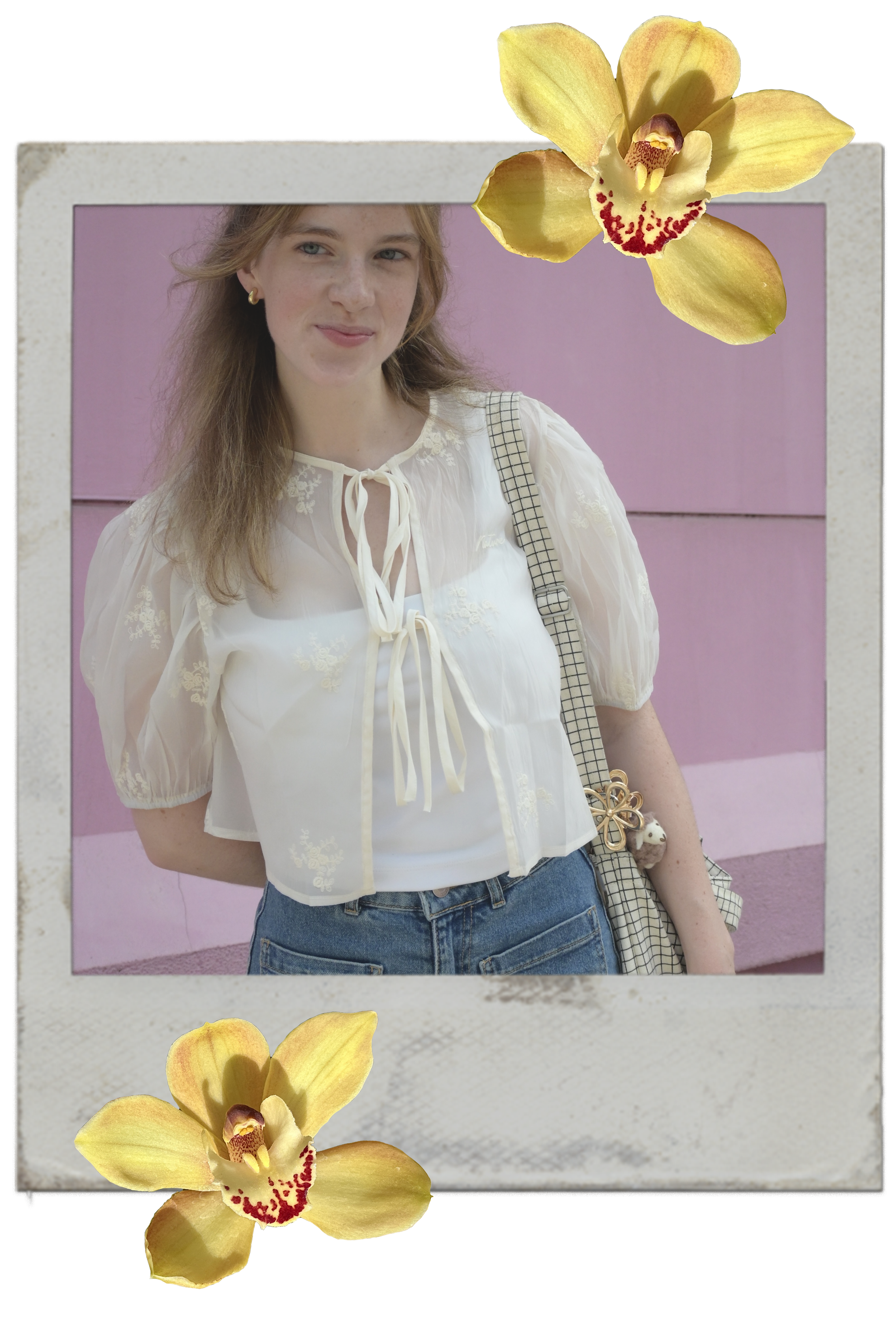 A woman standing in front of a pink wall, wearing a white blouse, blue jeans, and carrying a checkered shoulder bag, with yellow orchid flowers overlaid at the top right and bottom left corners of the image.