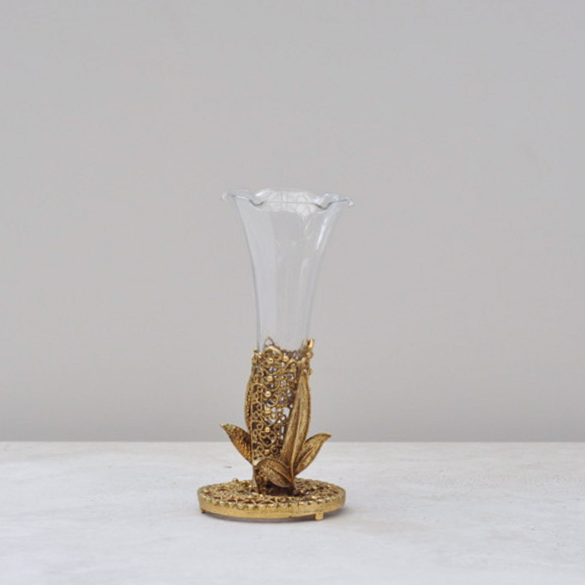 Side view of mid-century filigree bud vase with glass insert