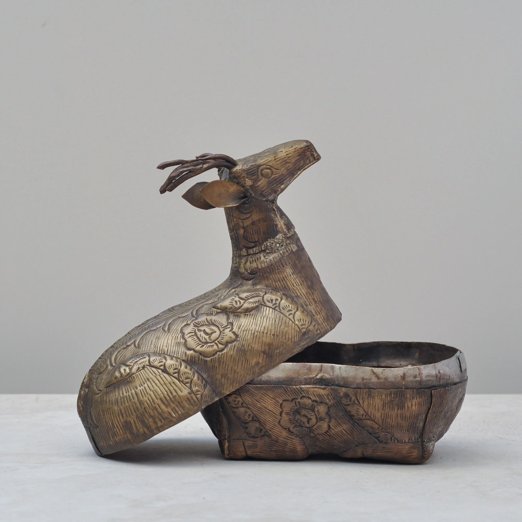 Vintage brass deer lidded box shown open, revealing its interior and hand-engraved exterior detail.