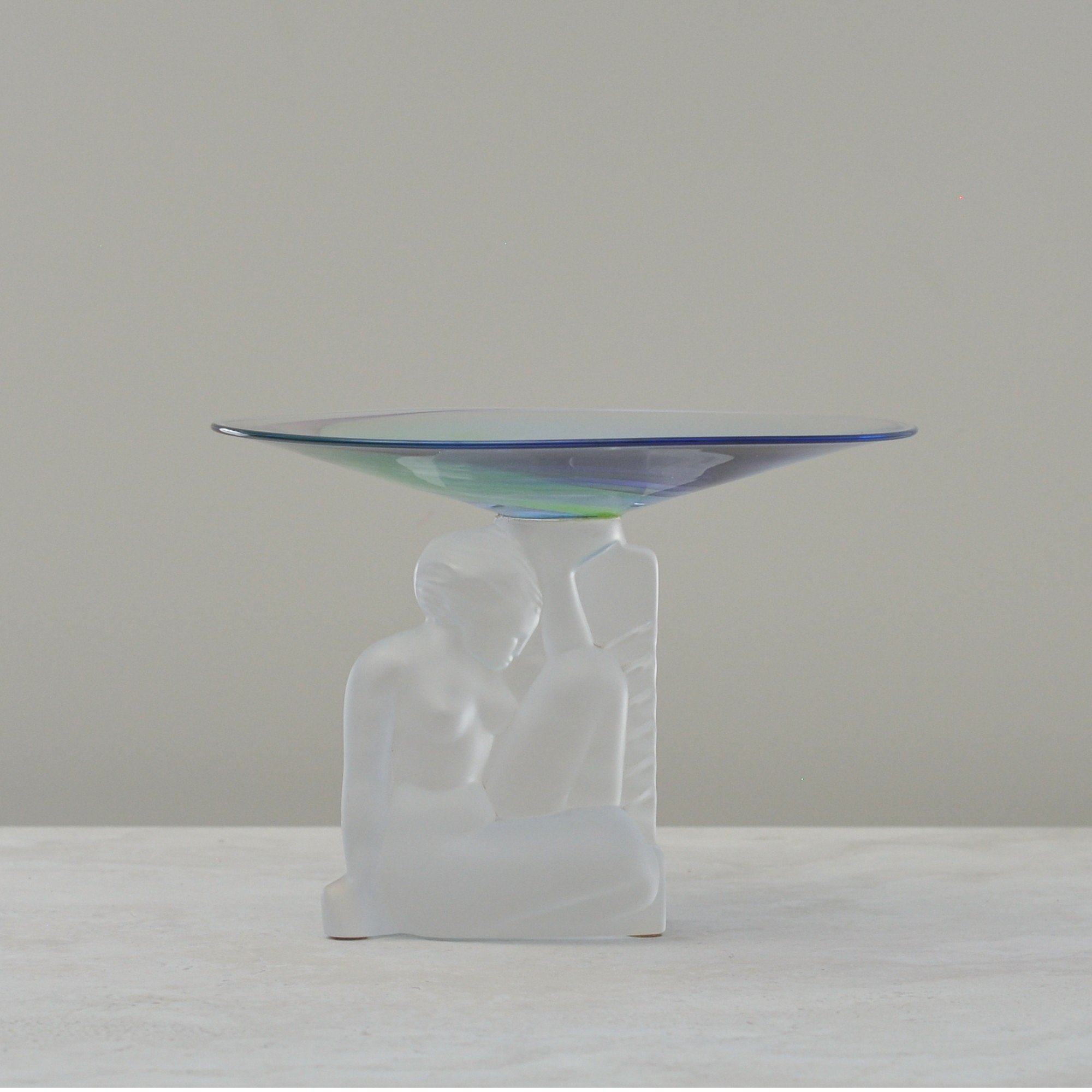 Level front view of the Cristal de Sèvres pedestal dish showing the sculptural frosted lady figure and iridescent crystal bowl.