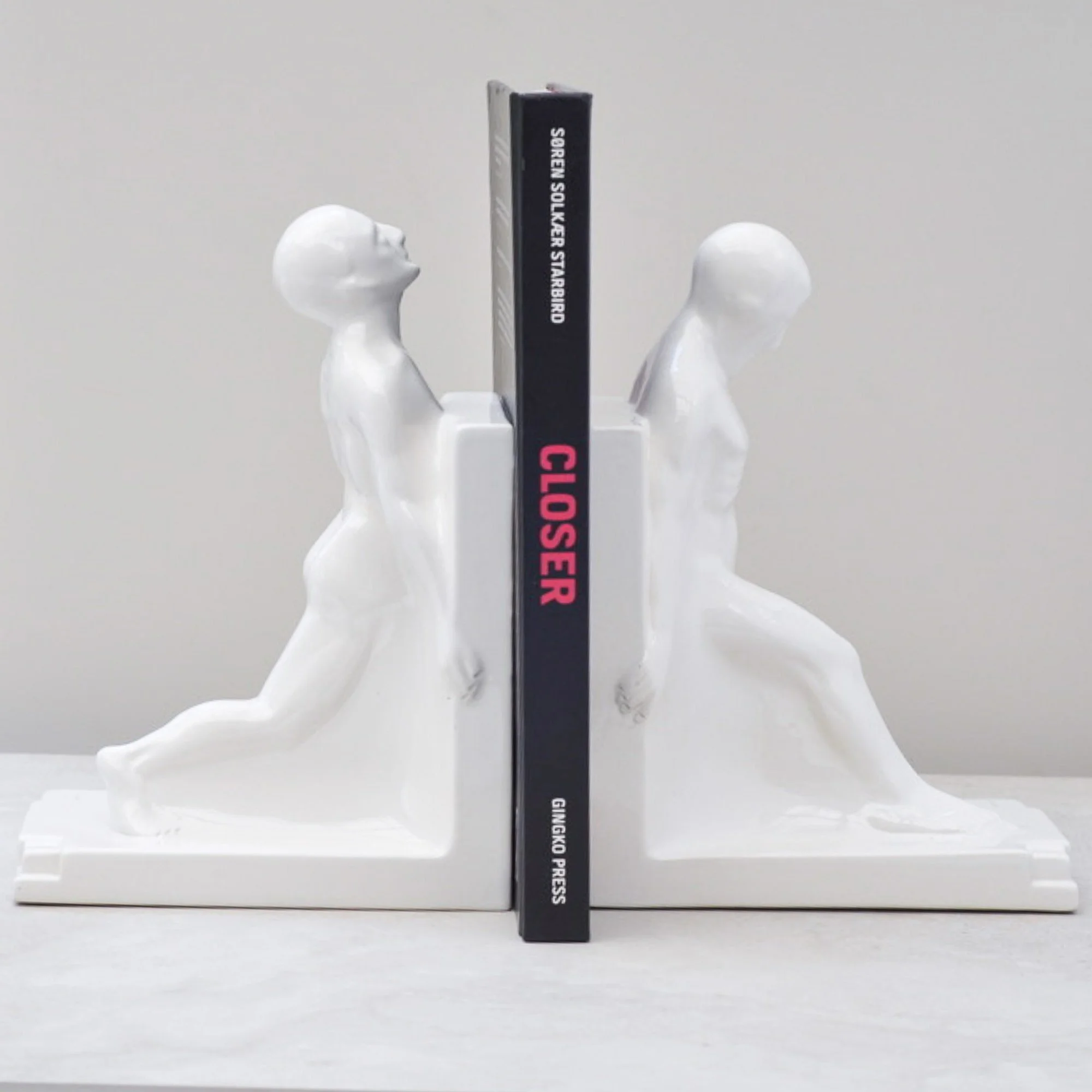 Large Art Deco nude male bookends with book for scale, white ceramic, Godefridus Boonekamp