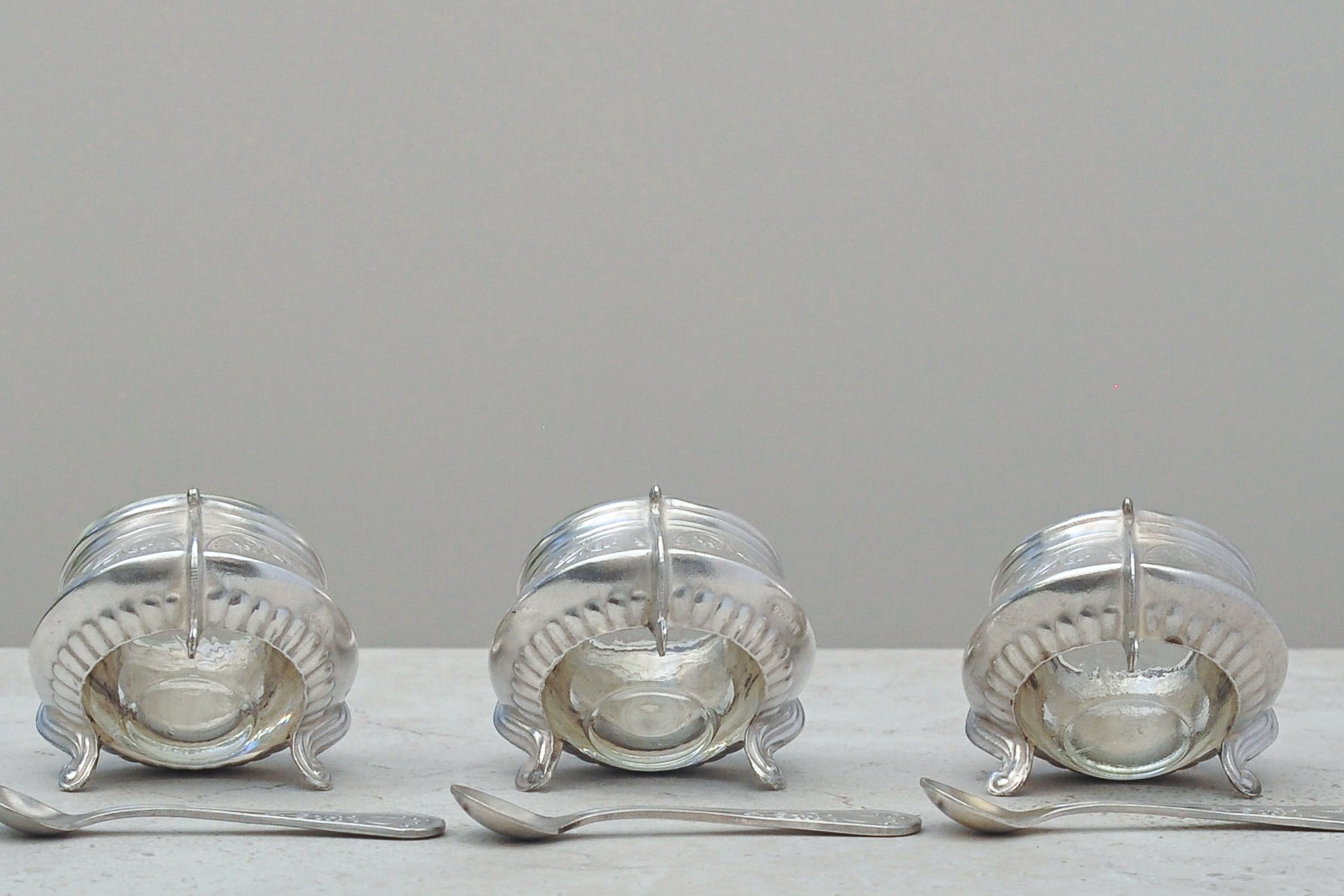 Base and back view of mid-century silver-plated salt cellars stamped IOMMET – vintage collectible tableware.