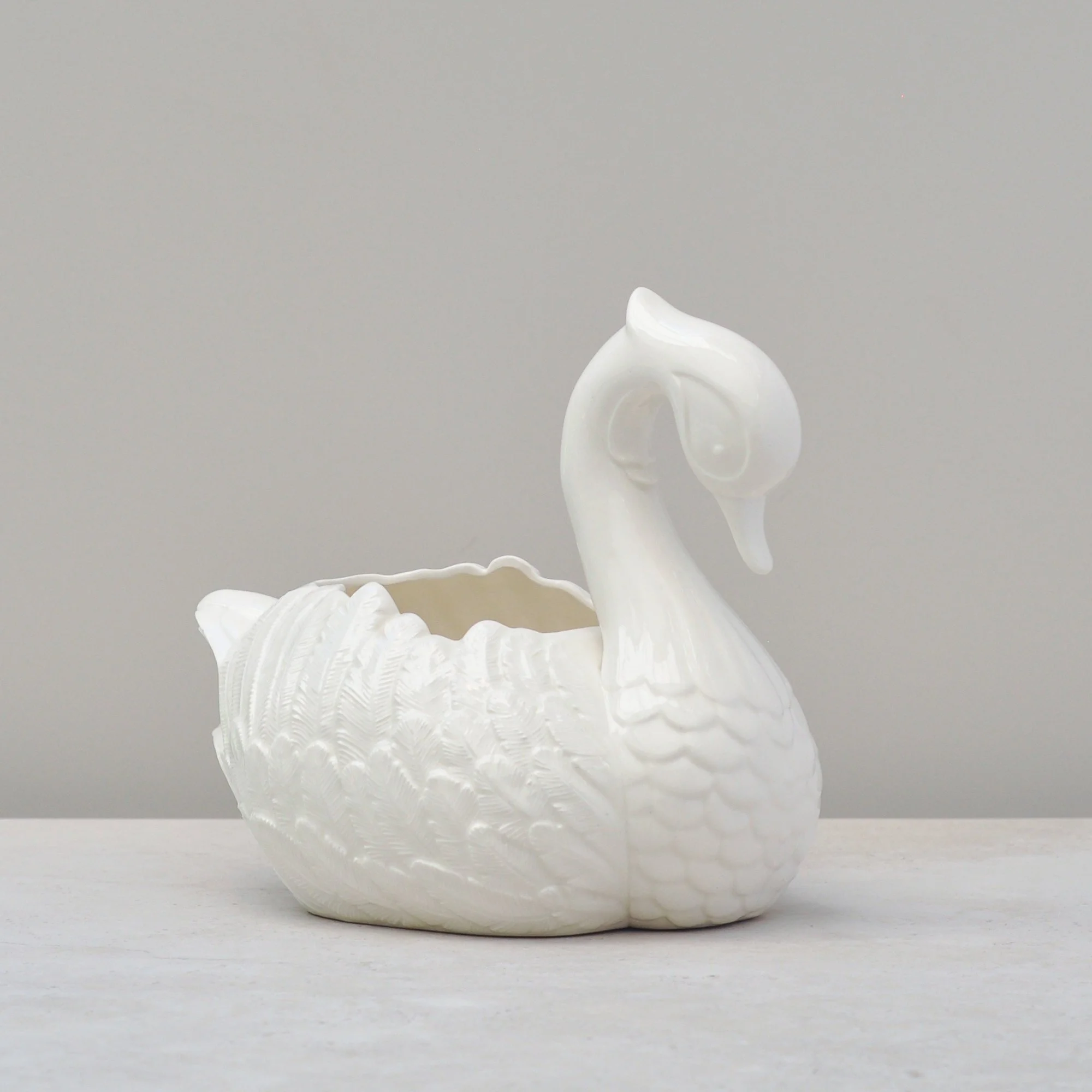 Top angle of handmade ceramic swan bowl, highlighting scalloped rim and swan shape.