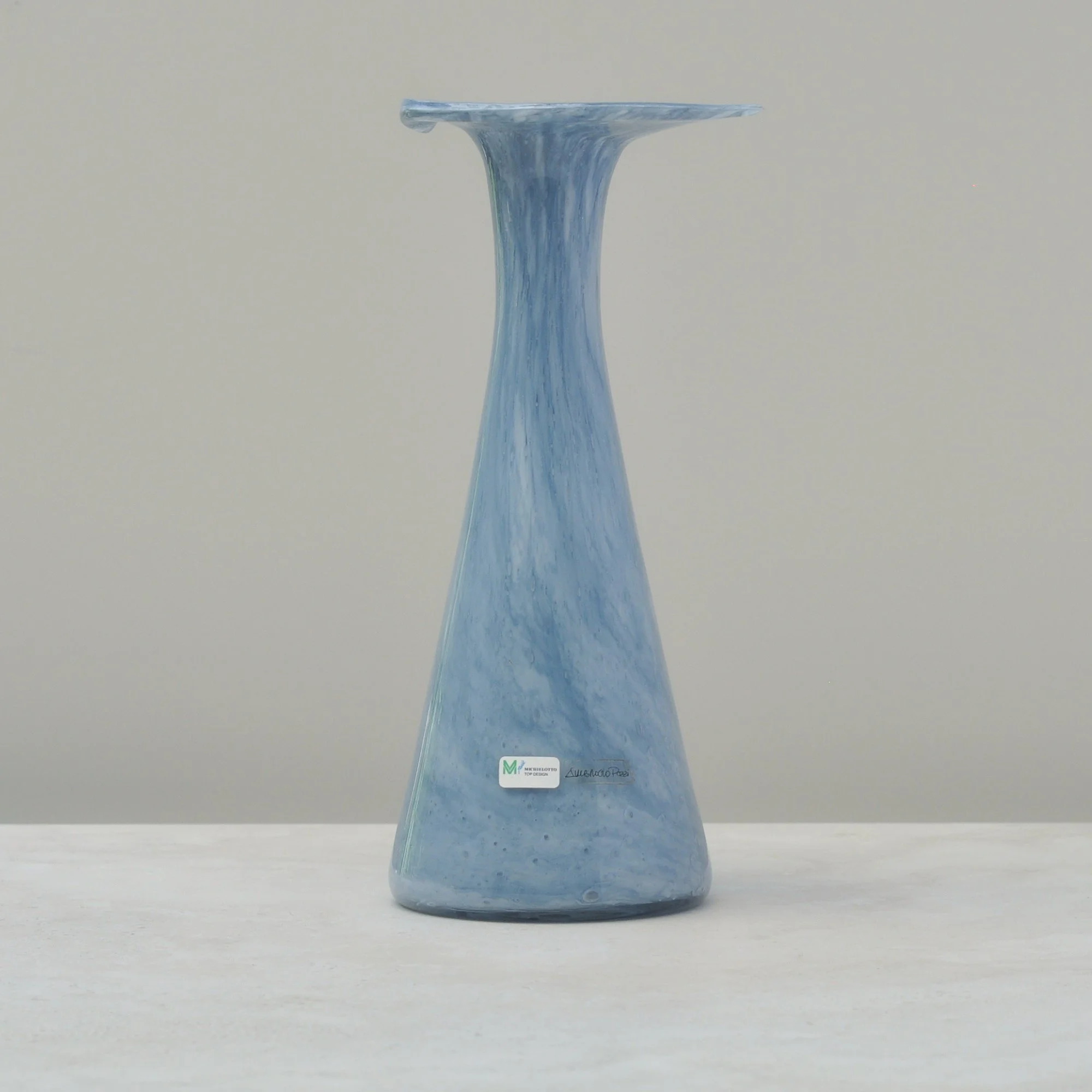 Light blue handblown glass vase showing the maker’s sticker from Subrocio Pozzi for Michielotto Top Design.