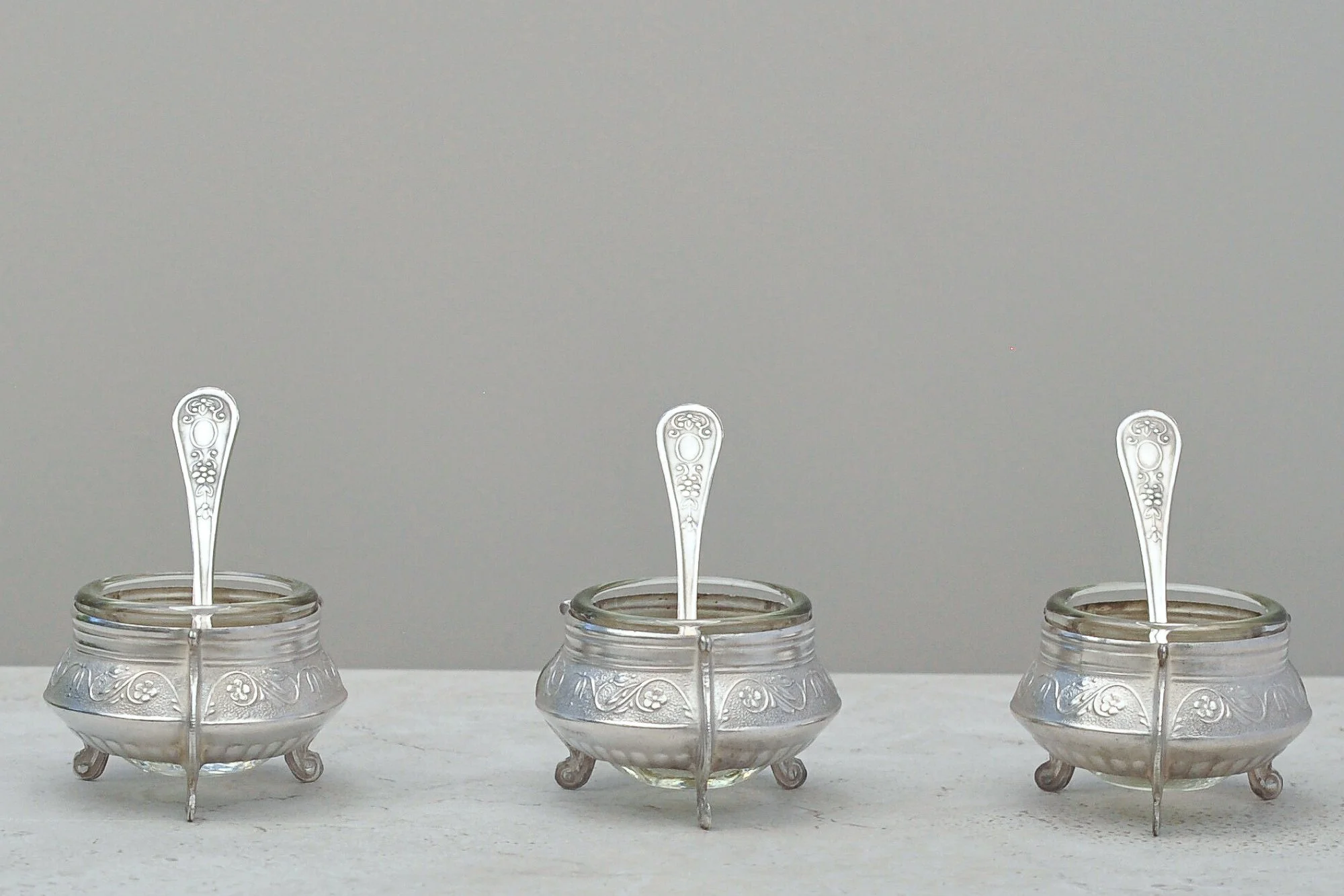 Vintage Russian IOMMET silver-plated salt cellar set with glass liners and petite spoons – detailed front-angle image