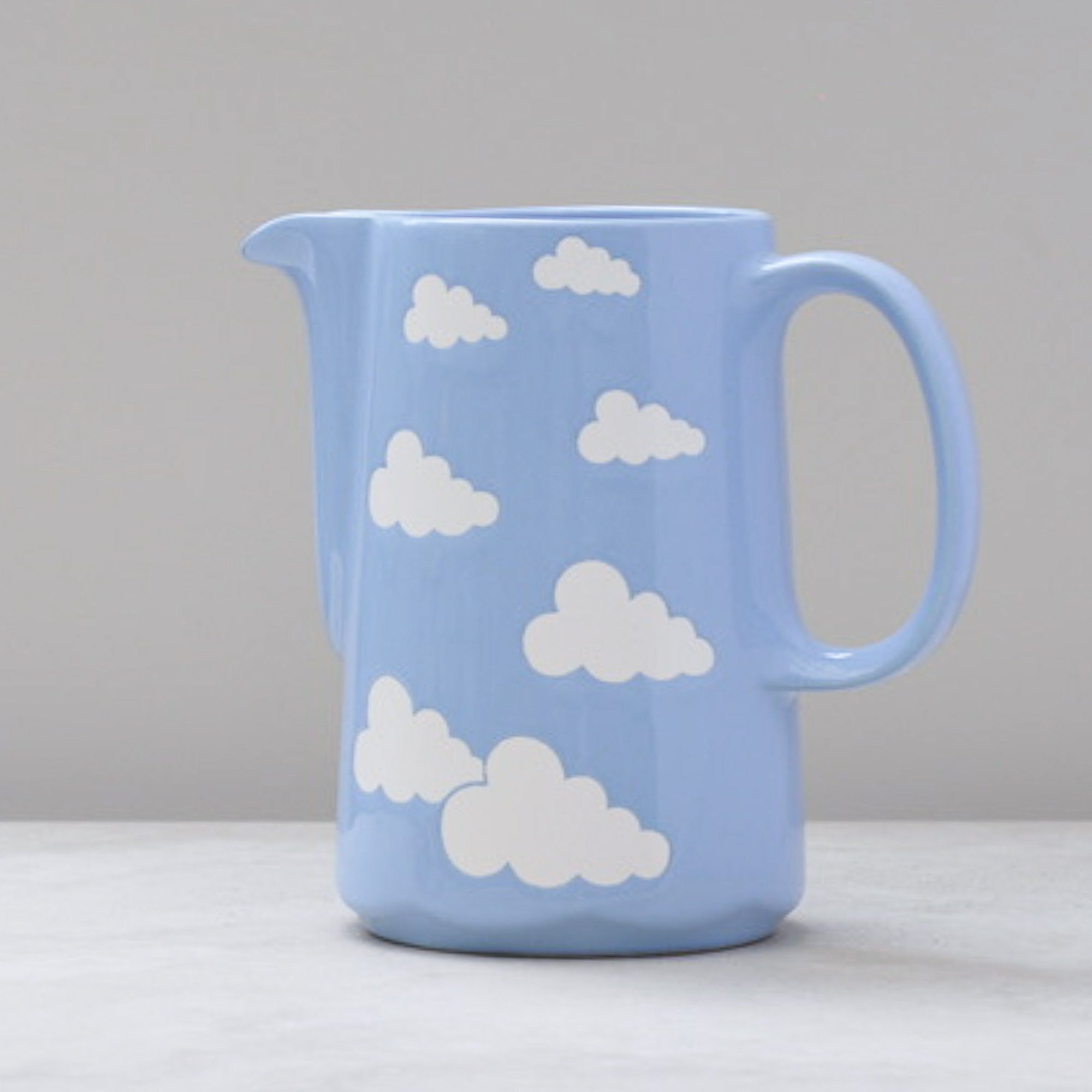 Vintage Waechtersbach blue cloud ceramic jug from West Germany on a neutral background.