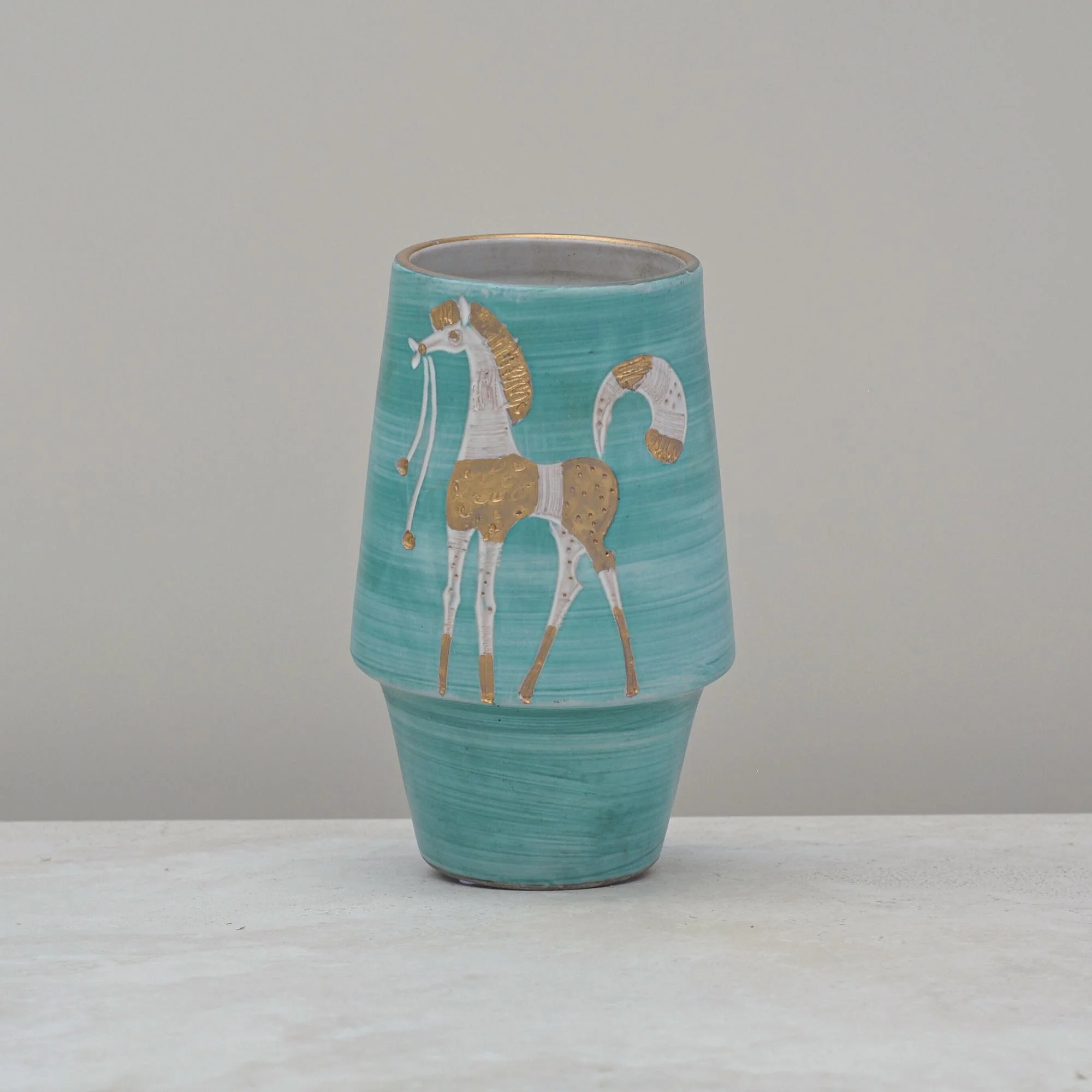 Front view of a mid-century aqua green Italian vase featuring a hand-painted white and gold horse motif.