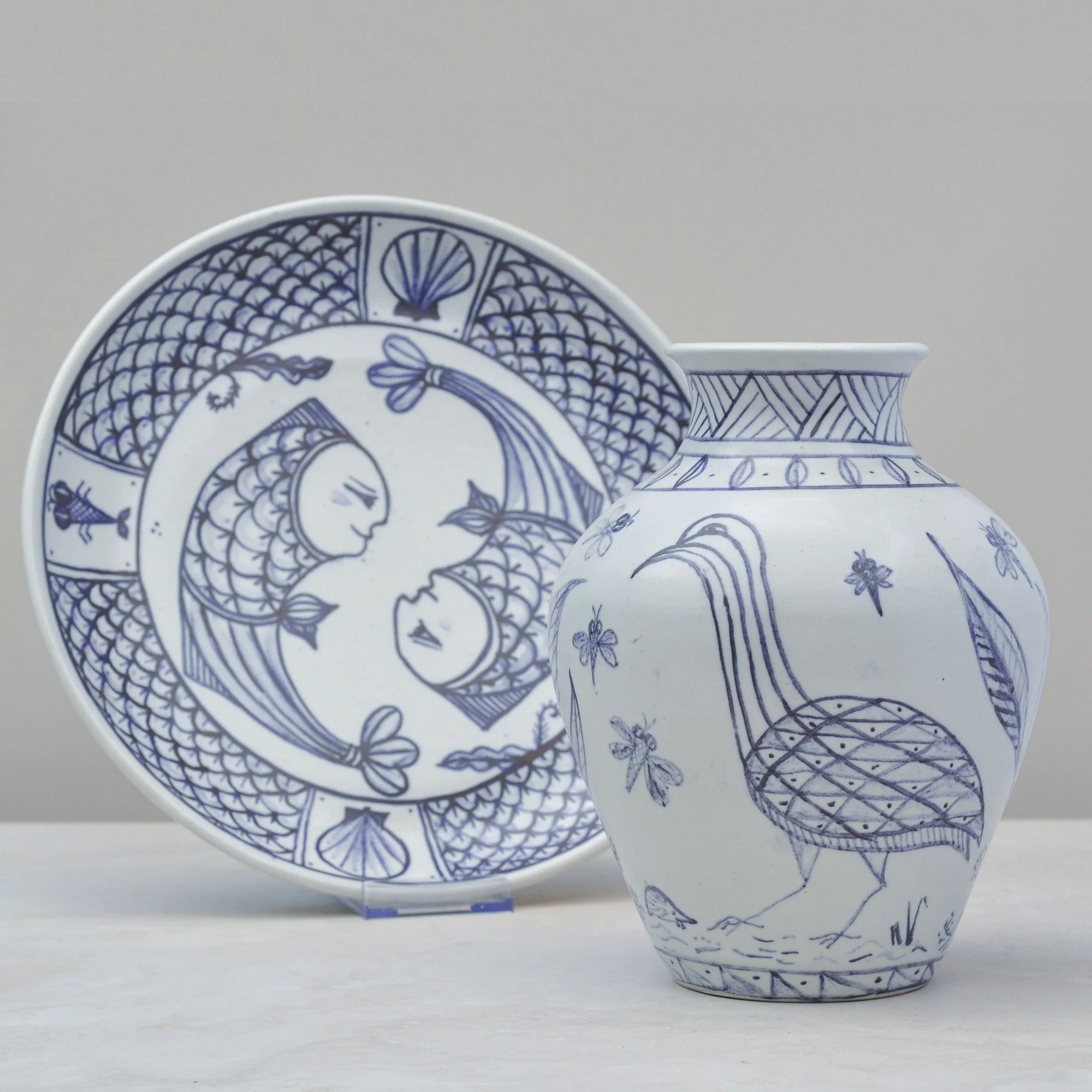 lue and white hand-painted vase and matching plate with bird and floral motifs, vintage decorative set.