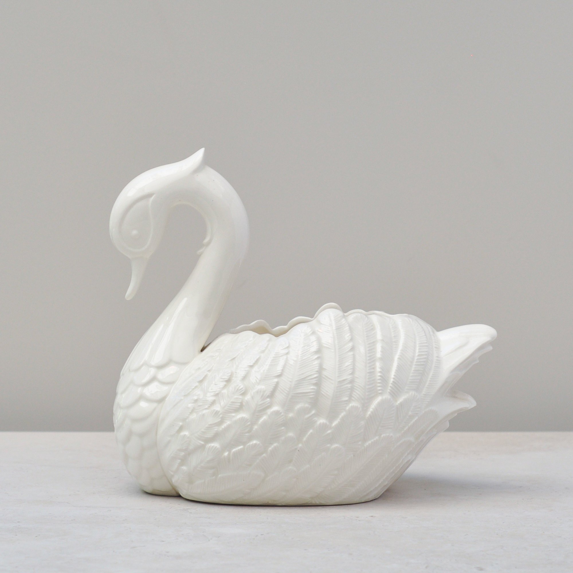 Side view of vintage 1987 handmade ceramic swan bowl showing feather detail.