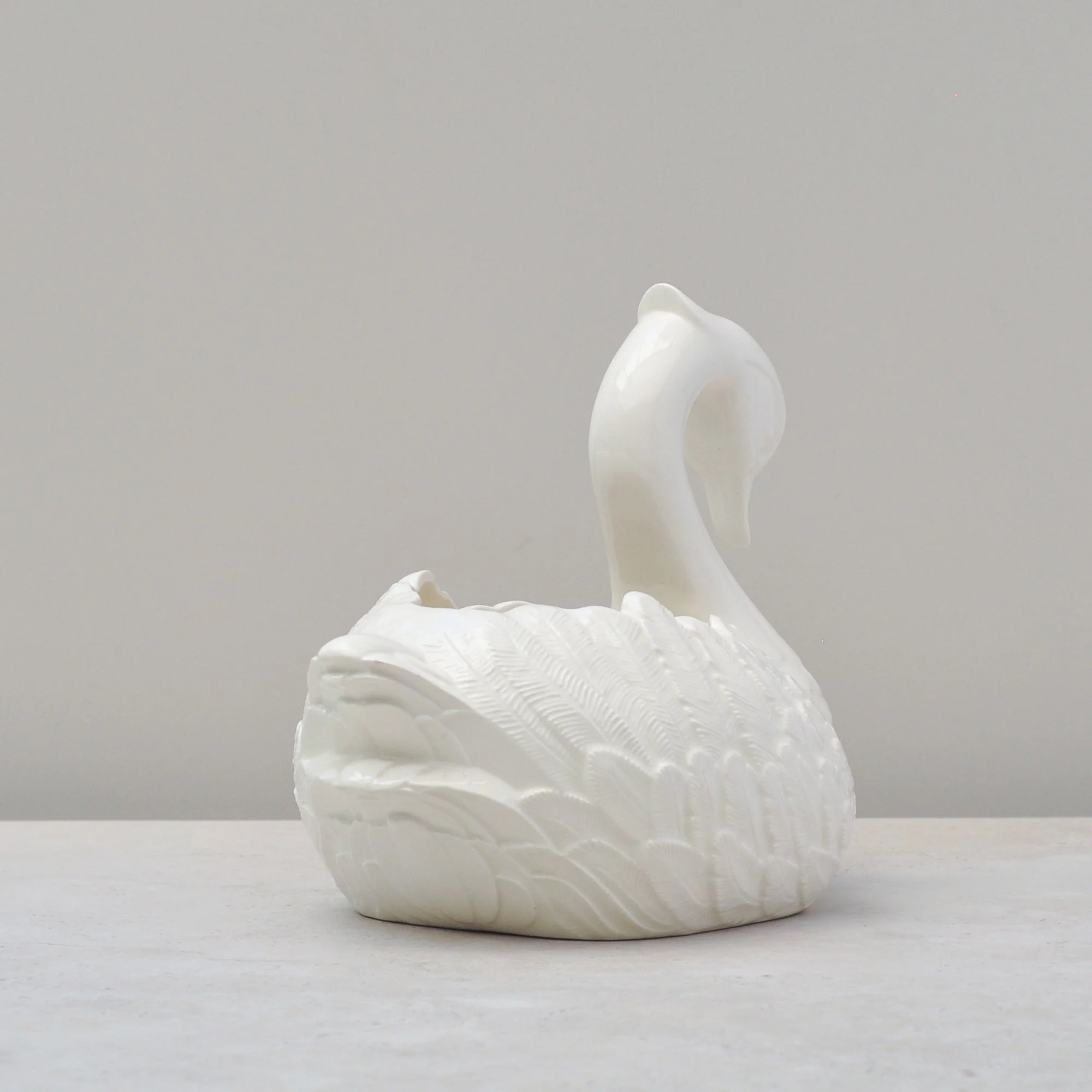 Rear view of vintage ceramic swan bowl showing tail and curved wing form.