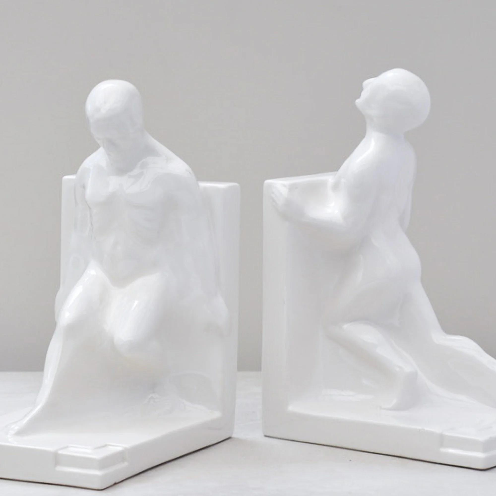 Pair of Art Deco nude male bookends showing sculptural form and posture, Dutch ceramics, 1930s