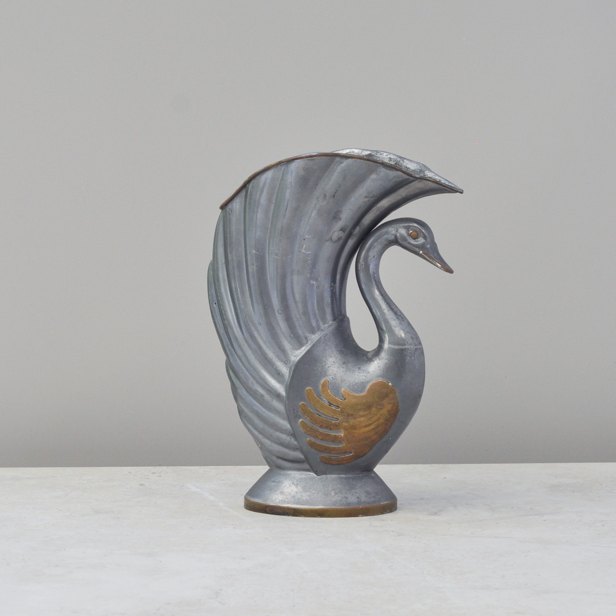 Profile view of mid-century metal swan vase Hong Kong